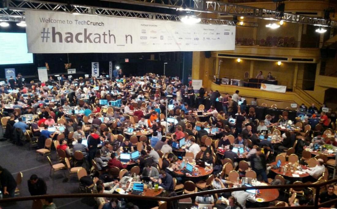Image of startup developers and tables in a large conference area at TechCrunch hackathon. Image of startup developers and tables in a large conference area at TechCrunch hackathon.
