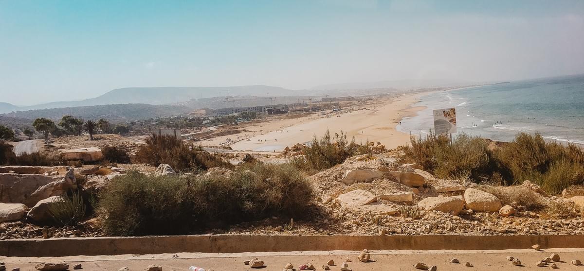 View of beach and water in the distance of Taghazout Bay, Morocco View of beach and water in the distance of Taghazout Bay, Morocco