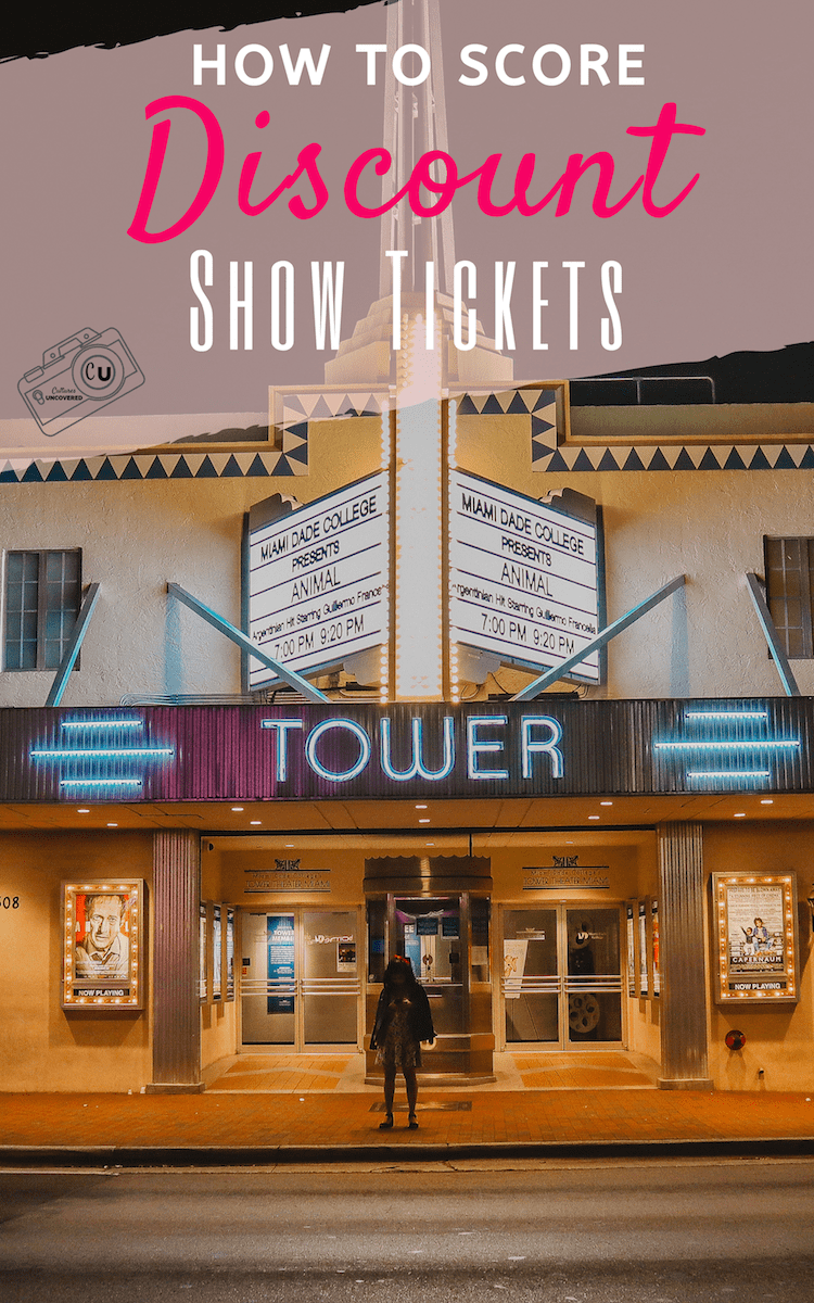 Hand holding an iPhone in front of the tower theater neon marquee for discount show tickets Hand holding an iPhone in front of the tower theater neon marquee for discount show tickets