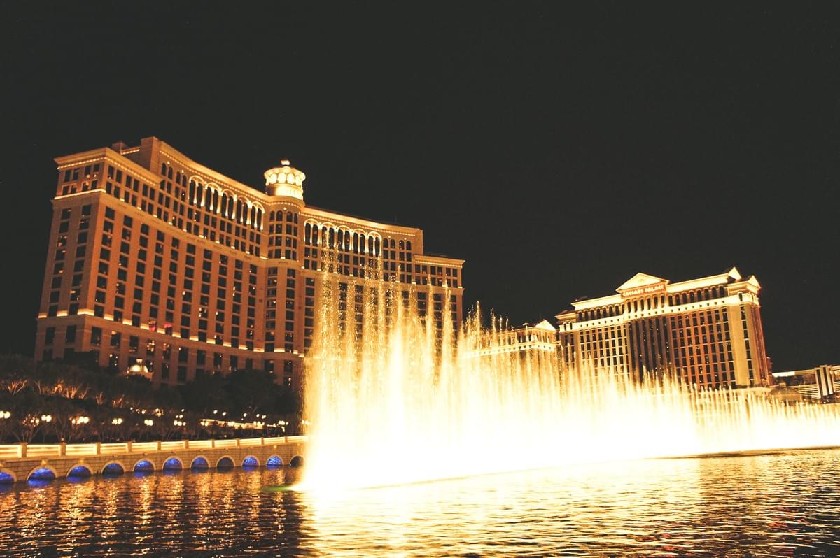 Lights and bellagio water fountain at night in front of the best hotel facade Lights and bellagio water fountain at night in front of the best hotel facade