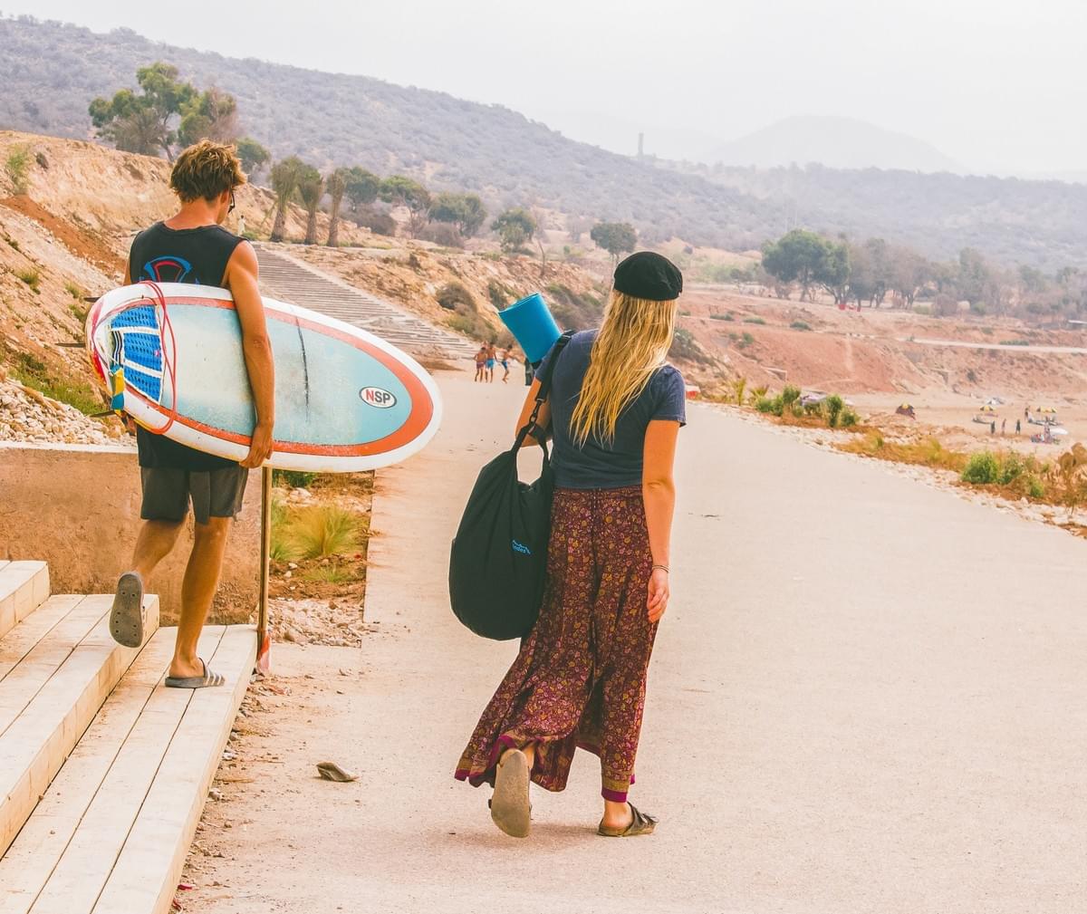 man, woman, surfboard, surf, bag, yoga mat, road, morocco, things to do man, woman, surfboard, surf, bag, yoga mat, road, morocco, things to do