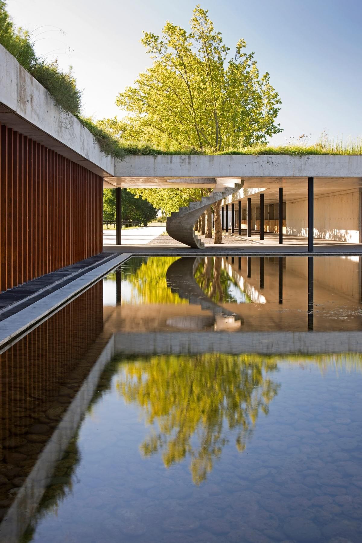 Stunning concrete stables features grassy roof for horses to graze Estudio Ramos Stunning concrete stables features grassy roof for horses to graze Estudio Ramos