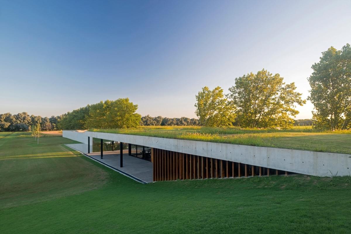Stunning concrete stables features grassy roof for horses to graze Estudio Ramos Stunning concrete stables features grassy roof for horses to graze Estudio Ramos