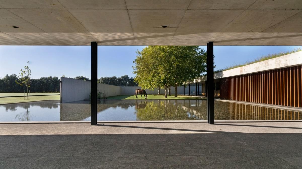 Stunning concrete stables features grassy roof for horses to graze Estudio Ramos Stunning concrete stables features grassy roof for horses to graze Estudio Ramos
