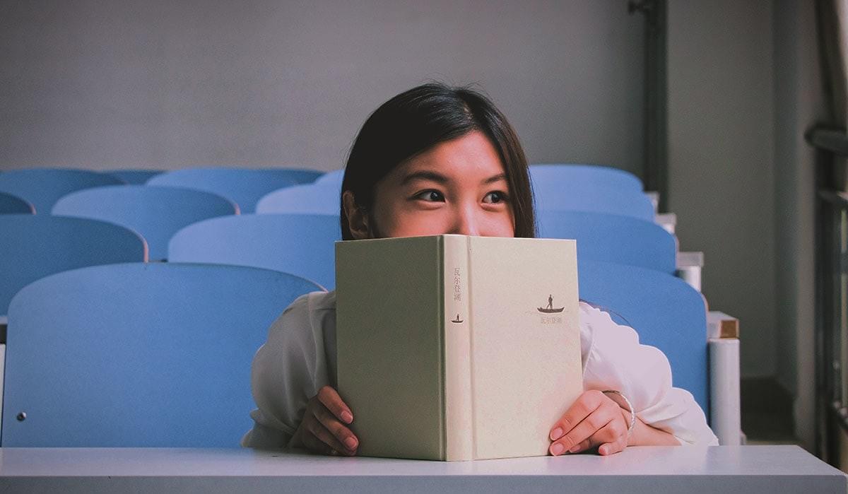 Image showing a young girl reading a Mandarin Chinese book in a classroom. Image showing a young girl reading a Mandarin Chinese book in a classroom.