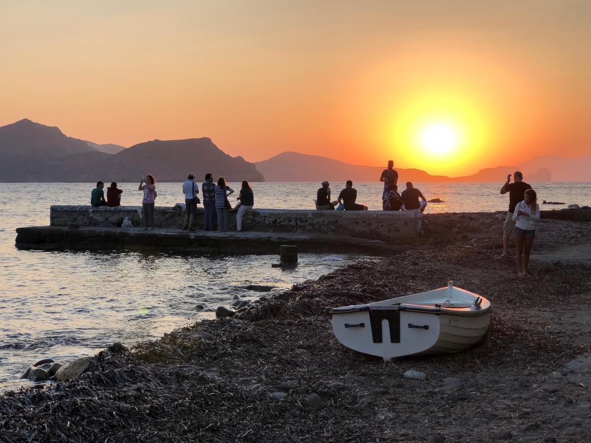 People gather to watch the sunset in Klima, Milos, Greece People gather to watch the sunset in Klima, Milos, Greece