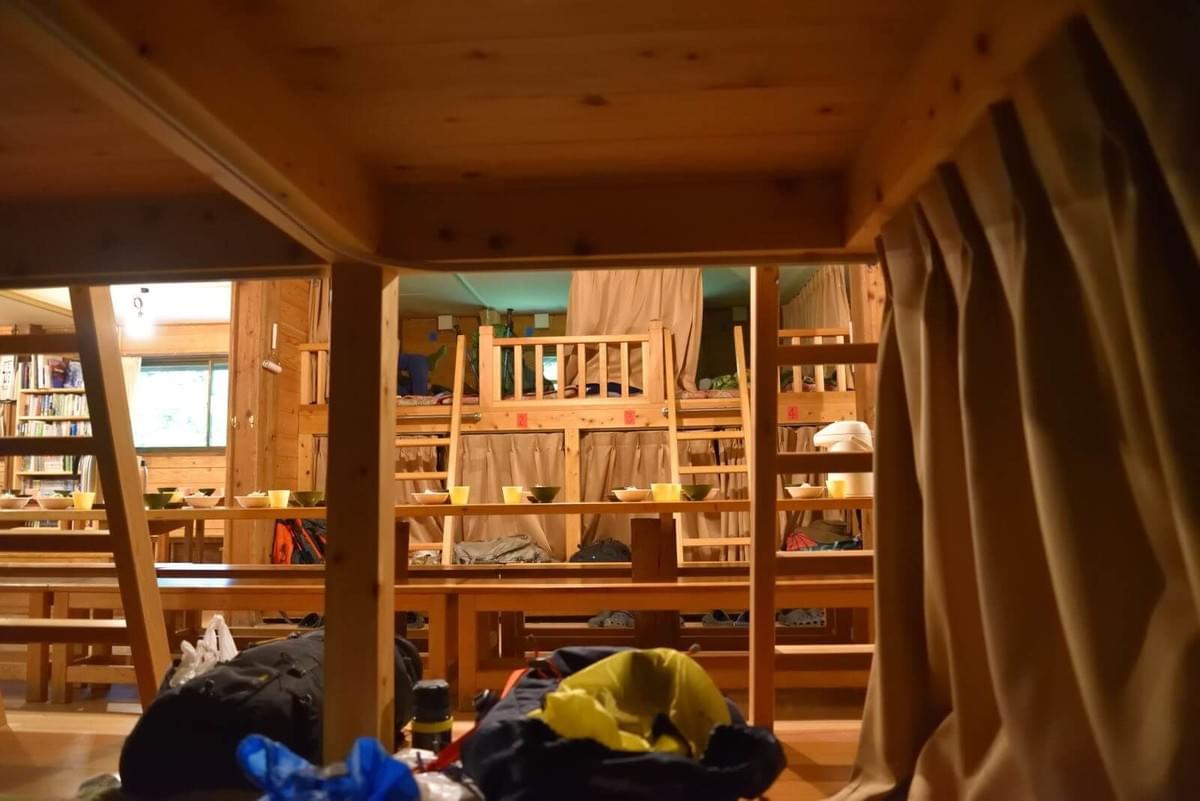 こもれび山荘の1階の寝床。カーテンで一人の空間に仕切ることができる。 こもれび山荘の1階の寝床。カーテンで一人の空間に仕切ることができる。