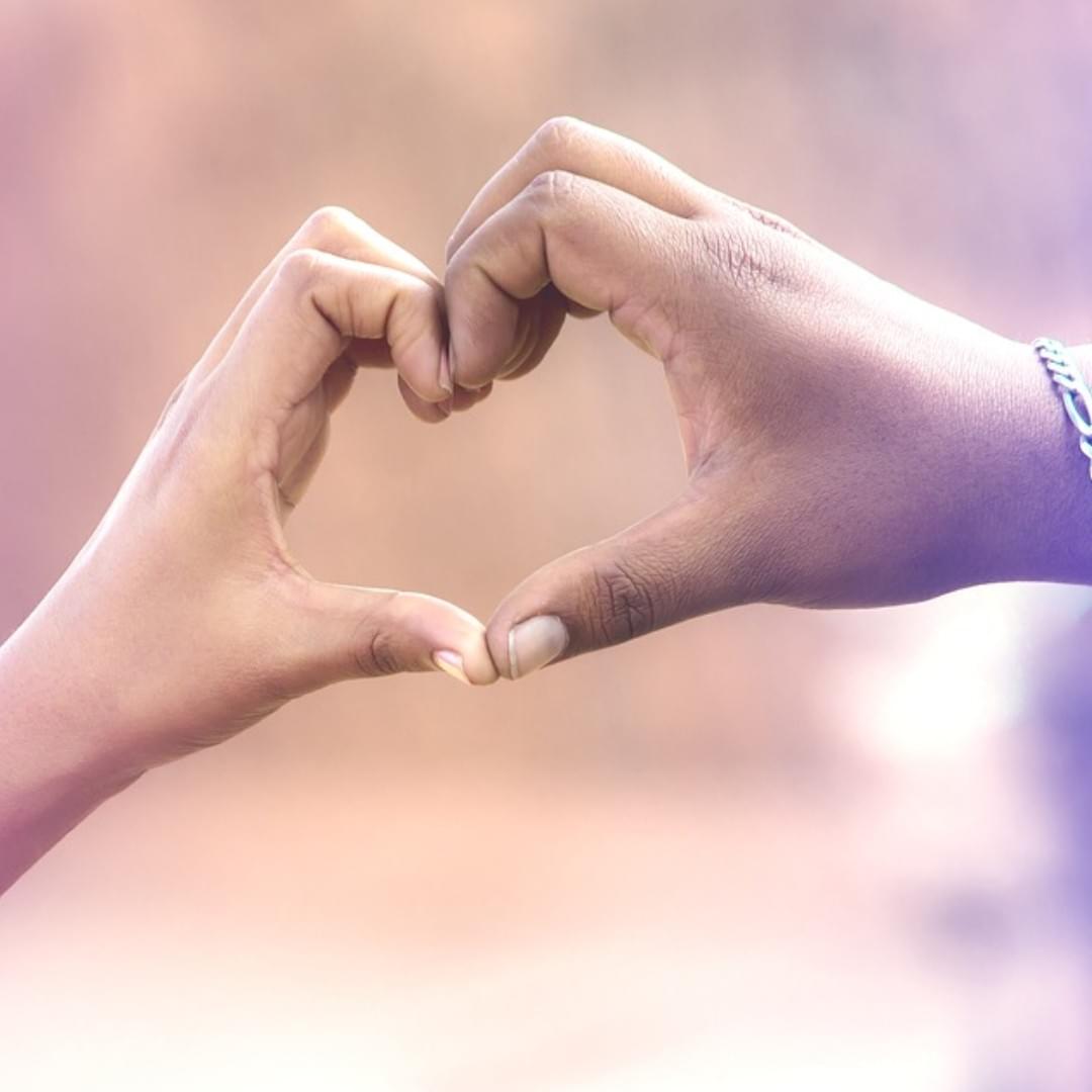 Two hands making a heart shape together Two hands making a heart shape together