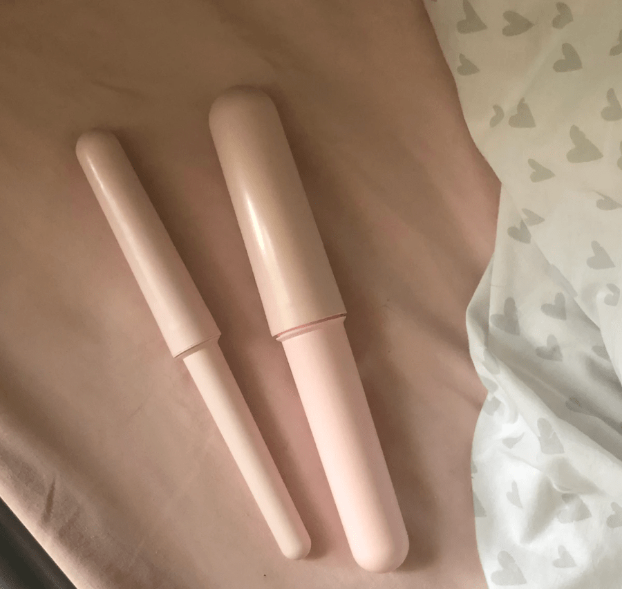 Baby Pink Plastic Vibrators in four sizes on pink sheet Baby Pink Plastic Vibrators in four sizes on pink sheet