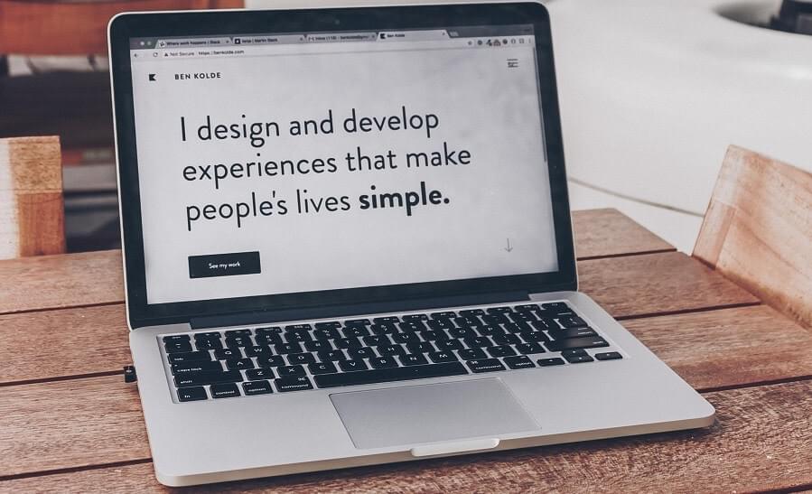 A computer showing on screen logo that reads: "I design and develop experiences that make people's lives simple." A computer showing on screen logo that reads: "I design and develop experiences that make people's lives simple."