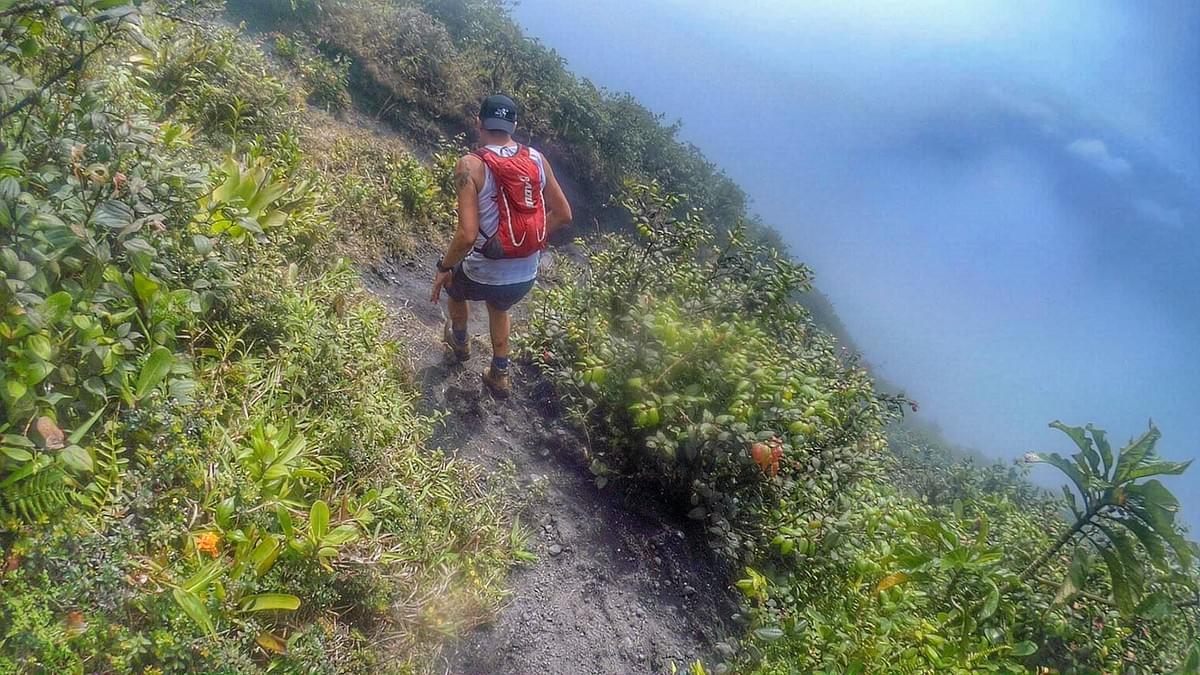 Running a trail that clings to the side of the volcano, a misty drop on the right hand side Running a trail that clings to the side of the volcano, a misty drop on the right hand side