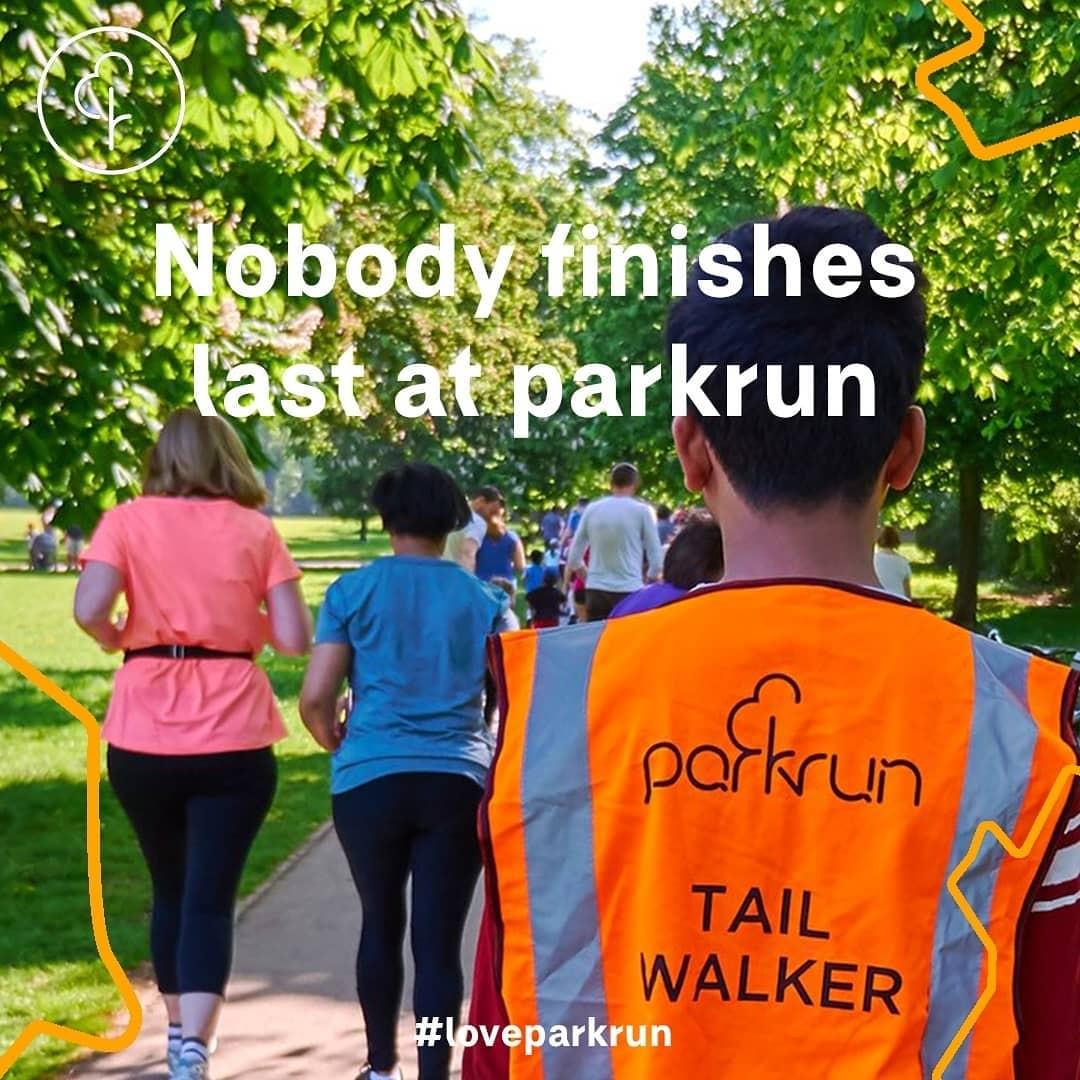 A parkun tail walker on a course behind two female parkrun participants A parkun tail walker on a course behind two female parkrun participants