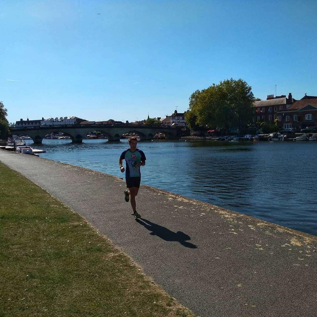 Man running on the Thames Path alongside the river in Henley-on-Thames Man running on the Thames Path alongside the river in Henley-on-Thames