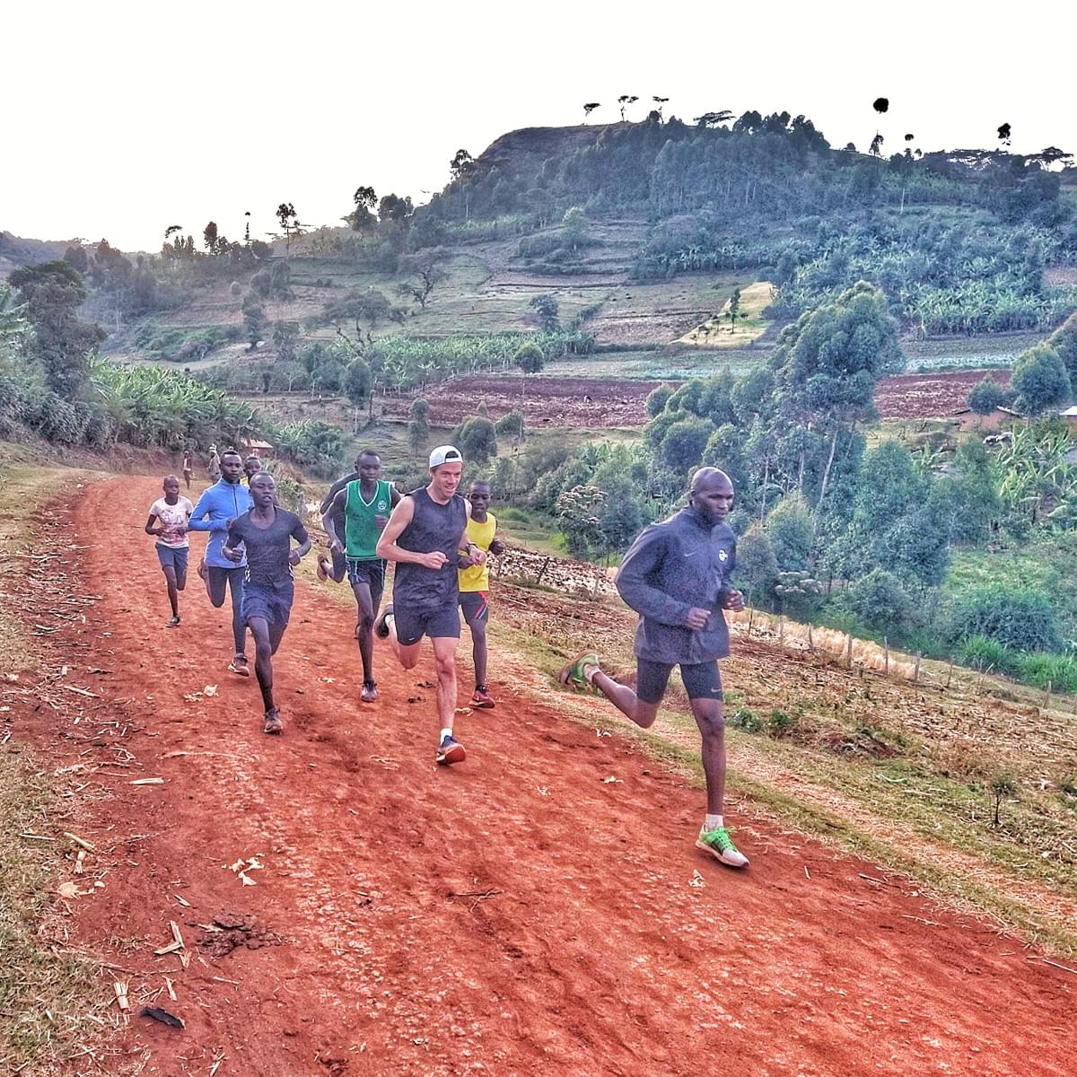 a group of Ugandan runners and international visitor running during a fartlek speedwork session in Kapchorwa, Uganda a group of Ugandan runners and international visitor running during a fartlek speedwork session in Kapchorwa, Uganda