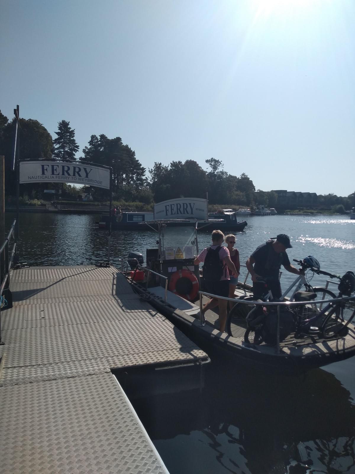 Group using the River Thames ferry crossing at Weybridge Group using the River Thames ferry crossing at Weybridge