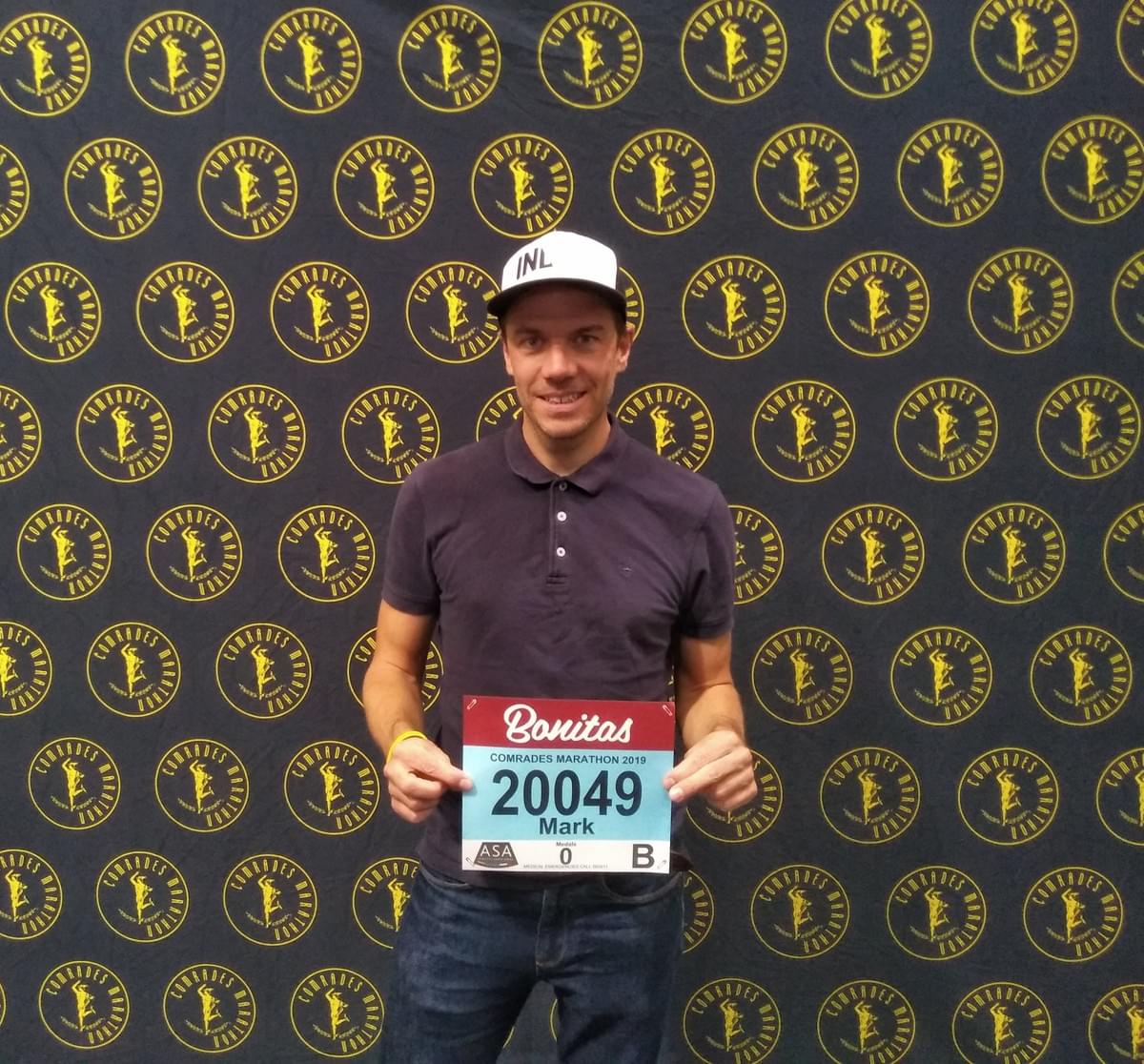 Ultra runner holding his race number at the 2019 Comrades Marathon expo in Durban Ultra runner holding his race number at the 2019 Comrades Marathon expo in Durban