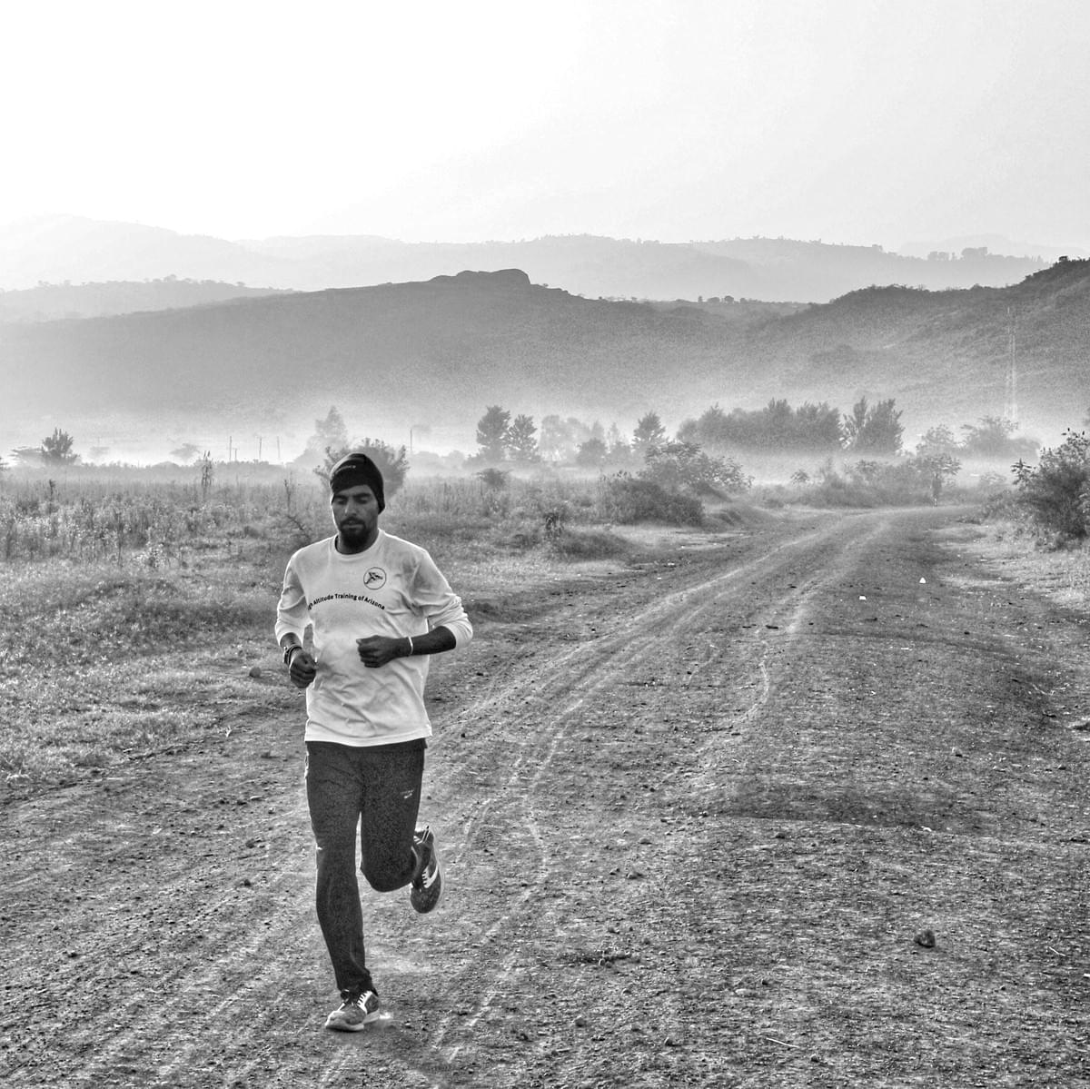 Mountain runner Najim Mahmoud running a tempo run on the plateau near Kapchorwa, Uganda Mountain runner Najim Mahmoud running a tempo run on the plateau near Kapchorwa, Uganda