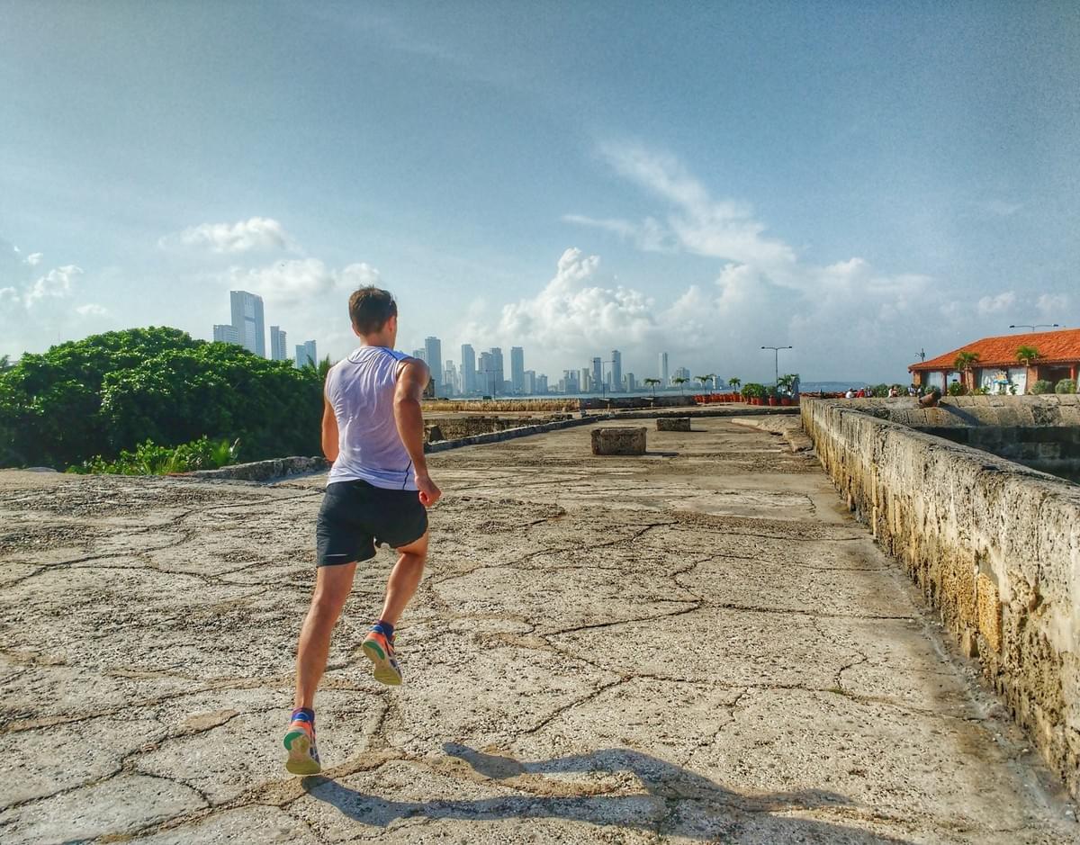 Running along the walls of Cartagena Old Town, cityscape in the background Running along the walls of Cartagena Old Town, cityscape in the background