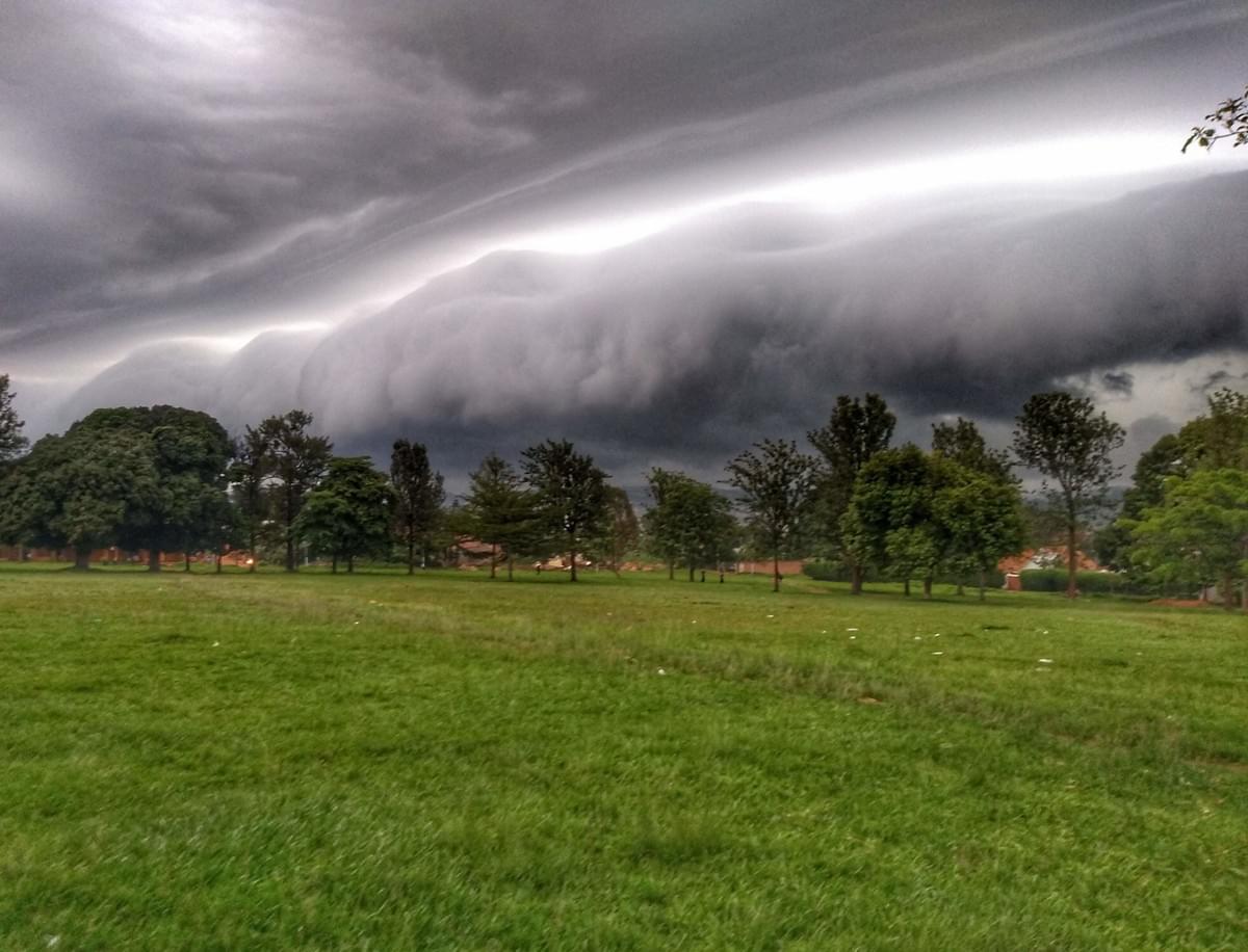 A huge storm front rolls in toward the grass and trees of Liberation Square, Masaka A huge storm front rolls in toward the grass and trees of Liberation Square, Masaka