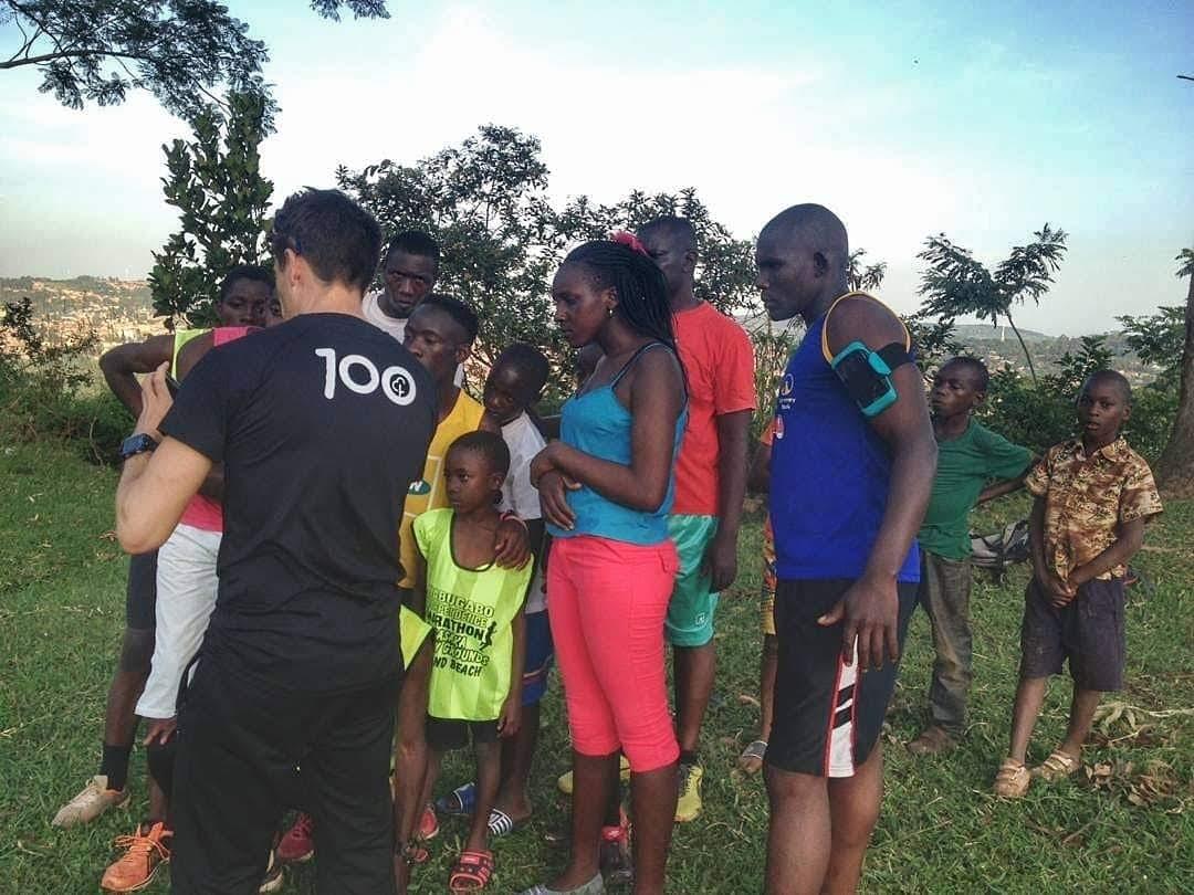 A coach showing video analysis on his phone to a group of local runners in Masaka. Uganda A coach showing video analysis on his phone to a group of local runners in Masaka. Uganda