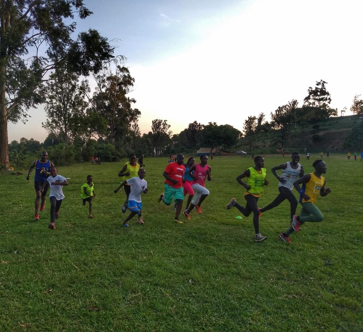 A group of local runners from young children to adults embark on an interval session on a sports field in Masaka, Uganda A group of local runners from young children to adults embark on an interval session on a sports field in Masaka, Uganda