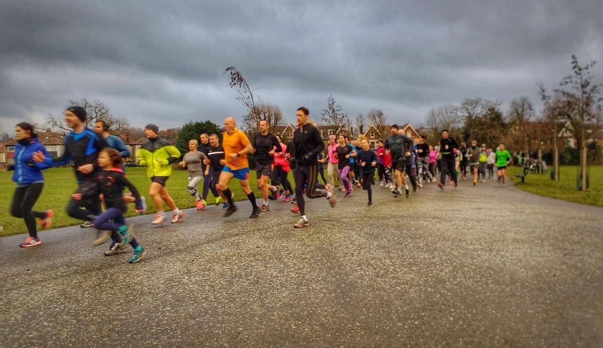 A large group of runners of all ages sprint away at the start of Peckham parkrun in South London, UK A large group of runners of all ages sprint away at the start of Peckham parkrun in South London, UK