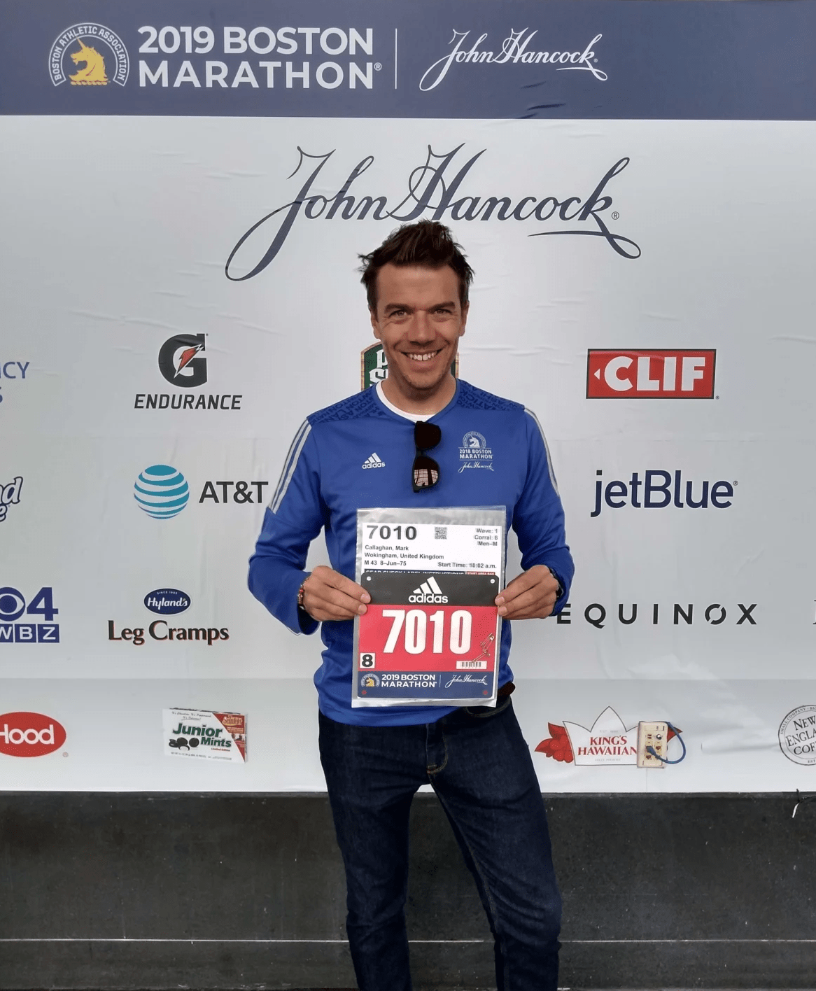 Runner holds race number at the 2019 Boston Marathon expo Runner holds race number at the 2019 Boston Marathon expo