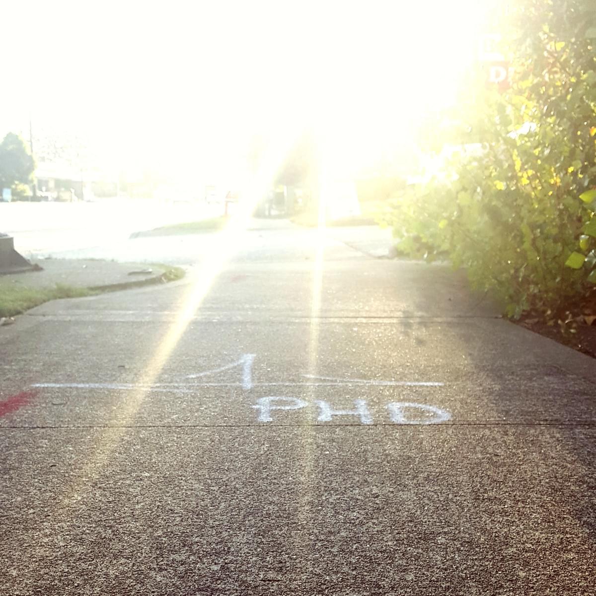 PhD paint on sidewalk at sunset PhD paint on sidewalk at sunset