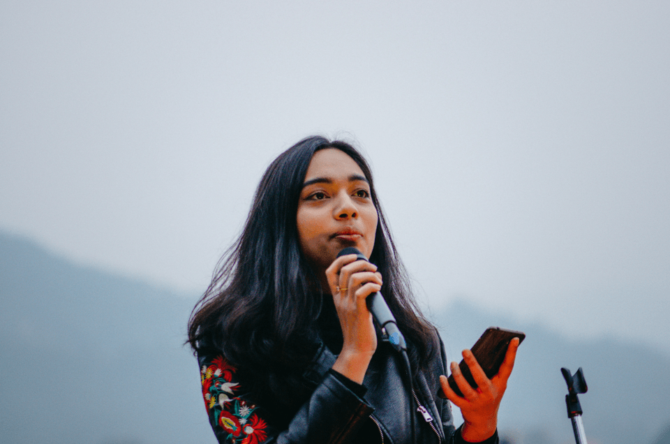 Woman standing confidently outdoors, embracing her strength and sacred truth