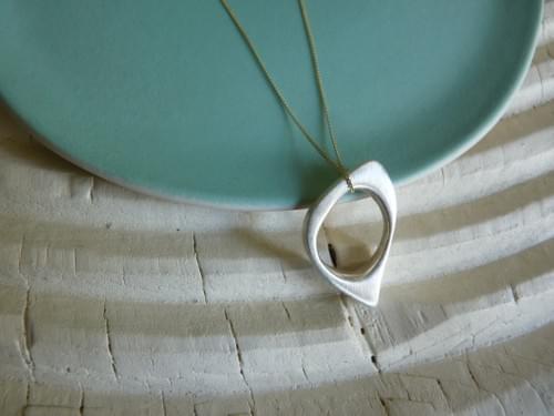 One Quirky Oval Pendant hung on 9ct gold chain