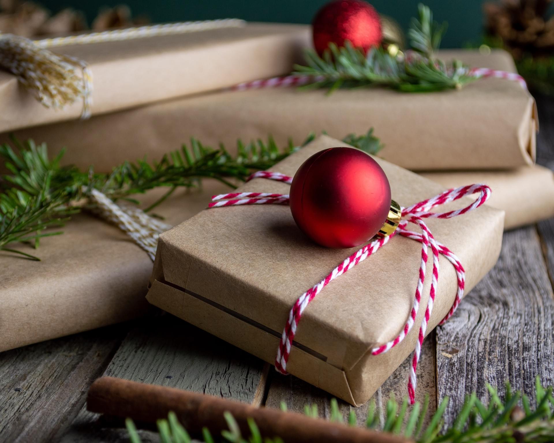 gifts wrapped in brown paper. photo by mel poole on unsplash.