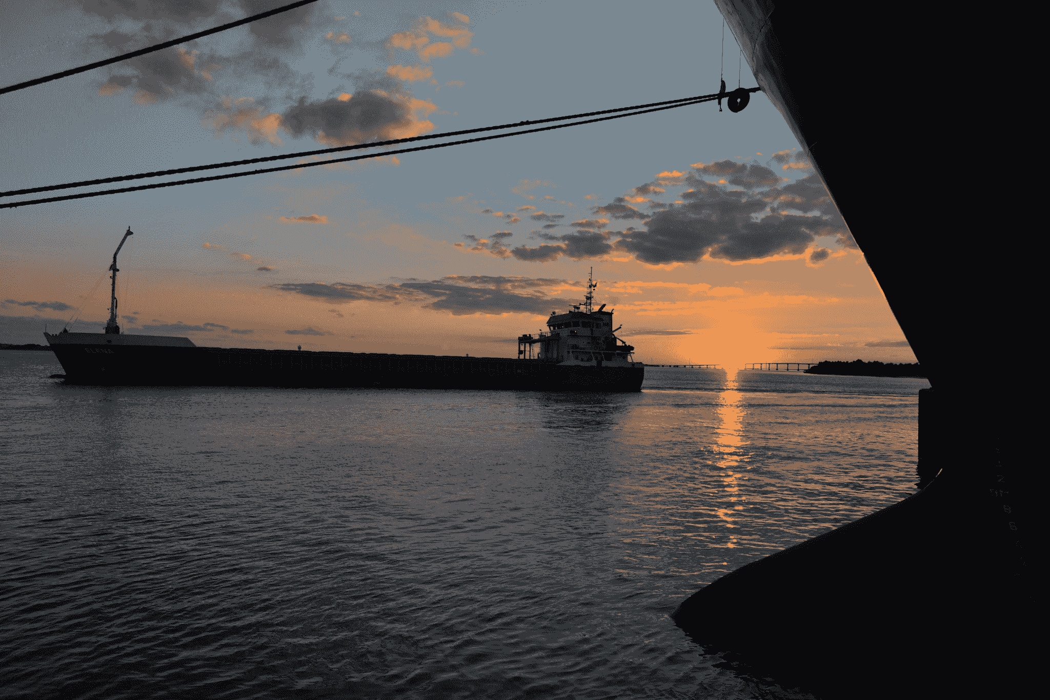 Landing craft vessel navigating during sunset.