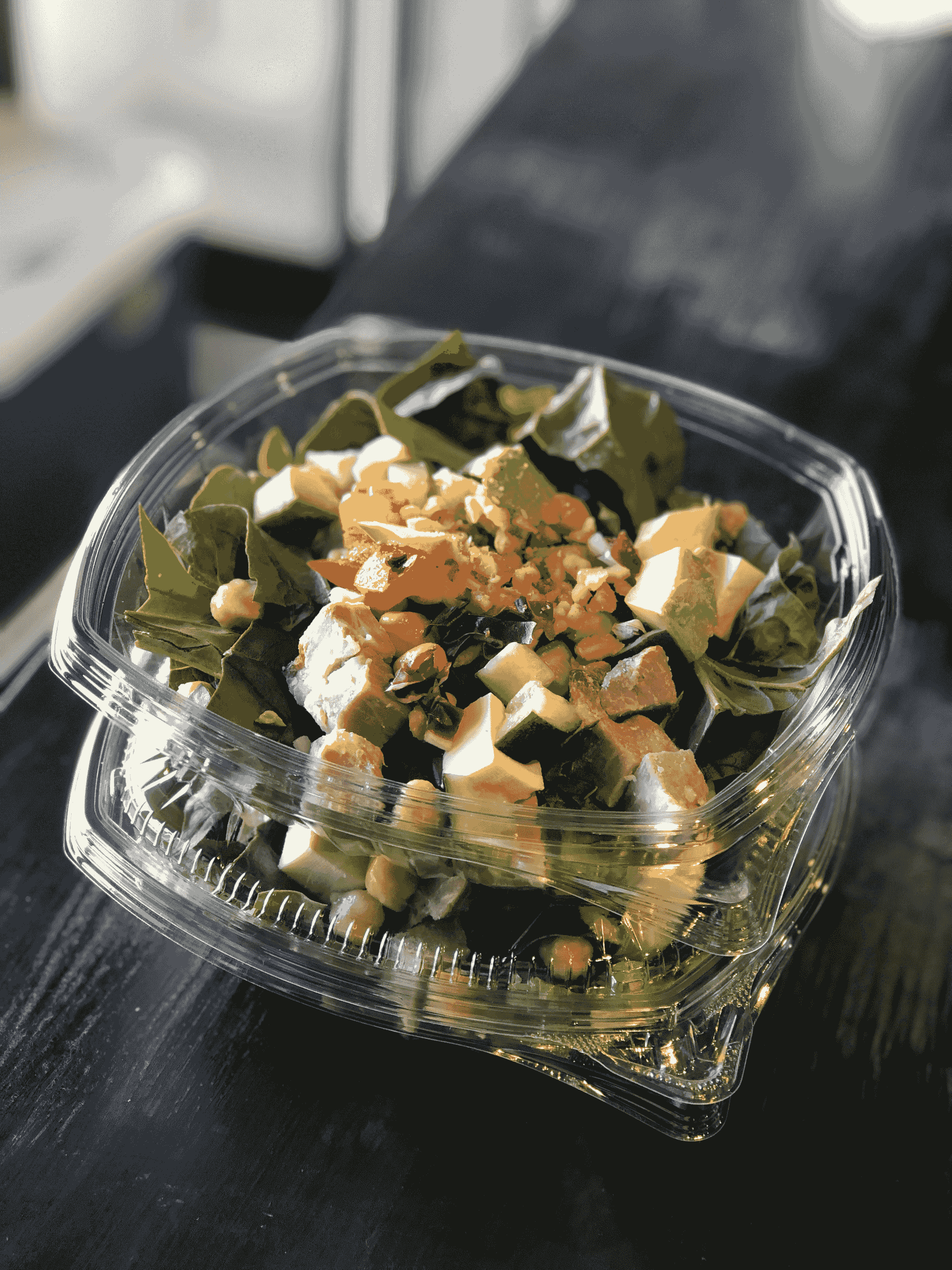 small takeout boxes filled with salad