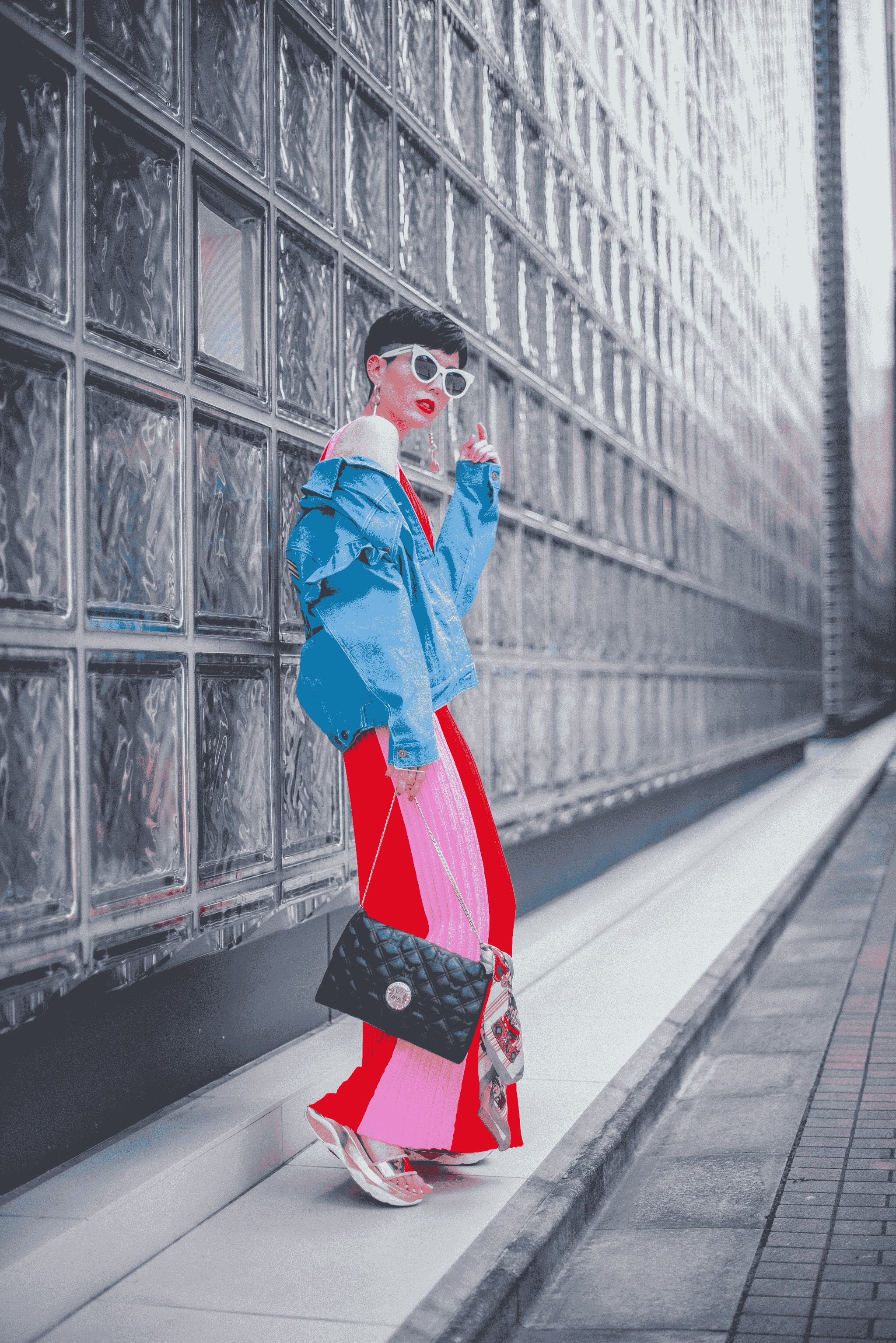 woman showcasing stylish outfit paired with thick rimmed glasses