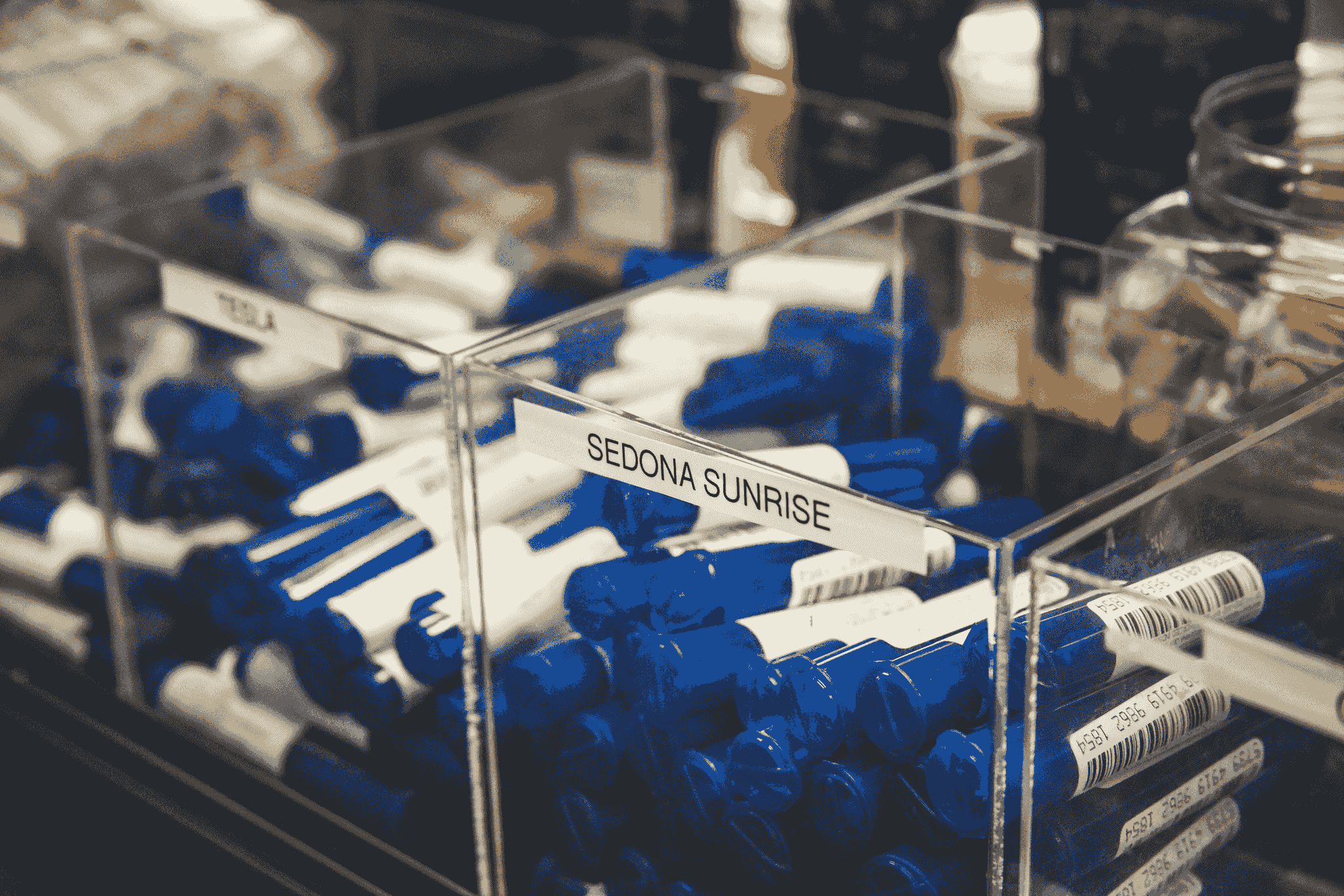 capsule container collection displayed on shelves