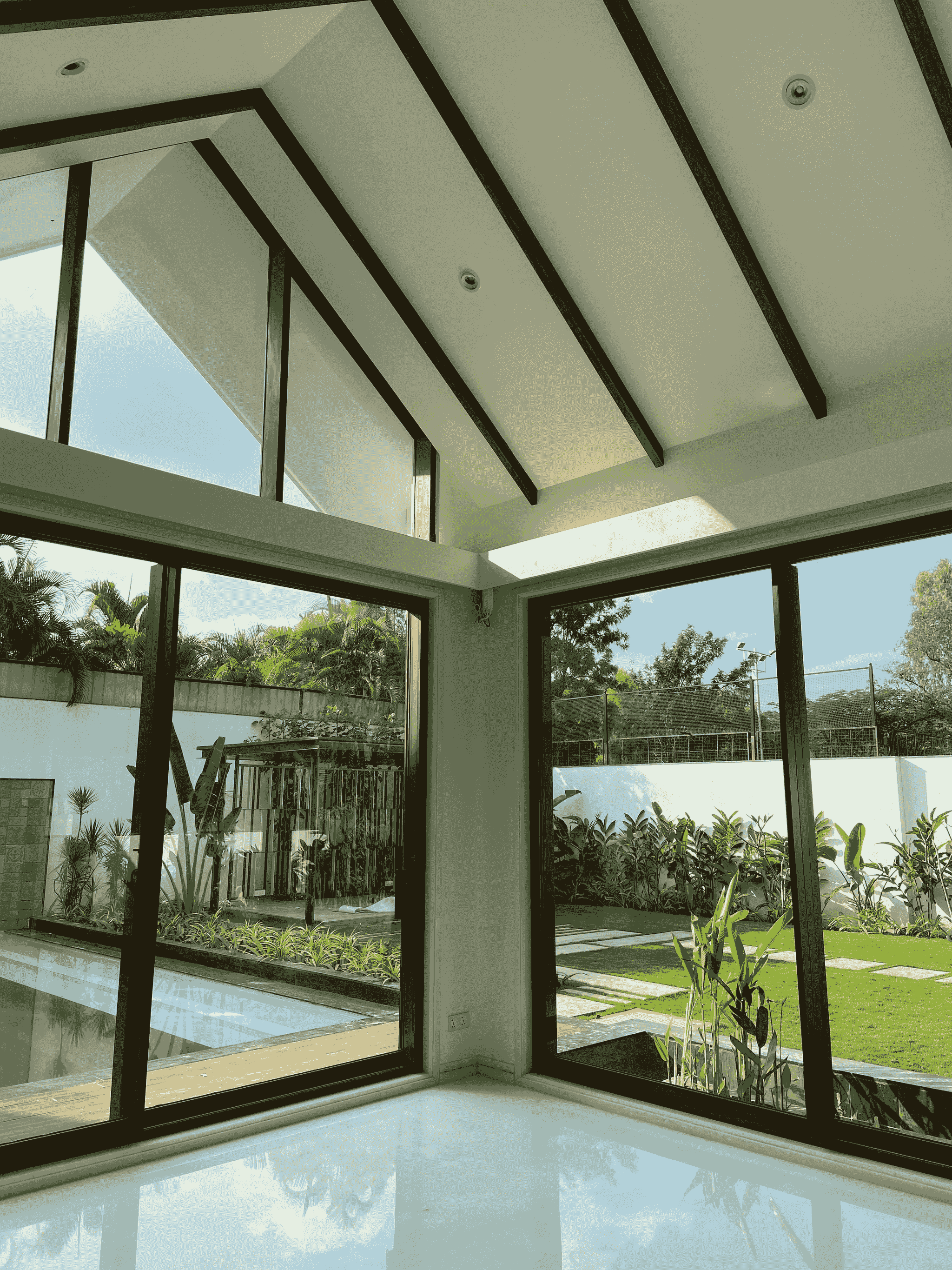 modern prefab house with glass walls and sun room