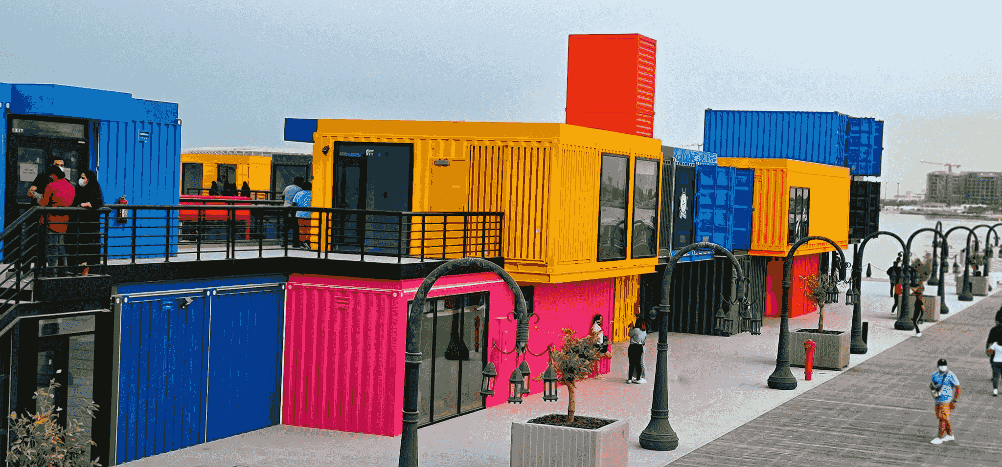 Vibrant shipping container shop exterior with customers browsing inside