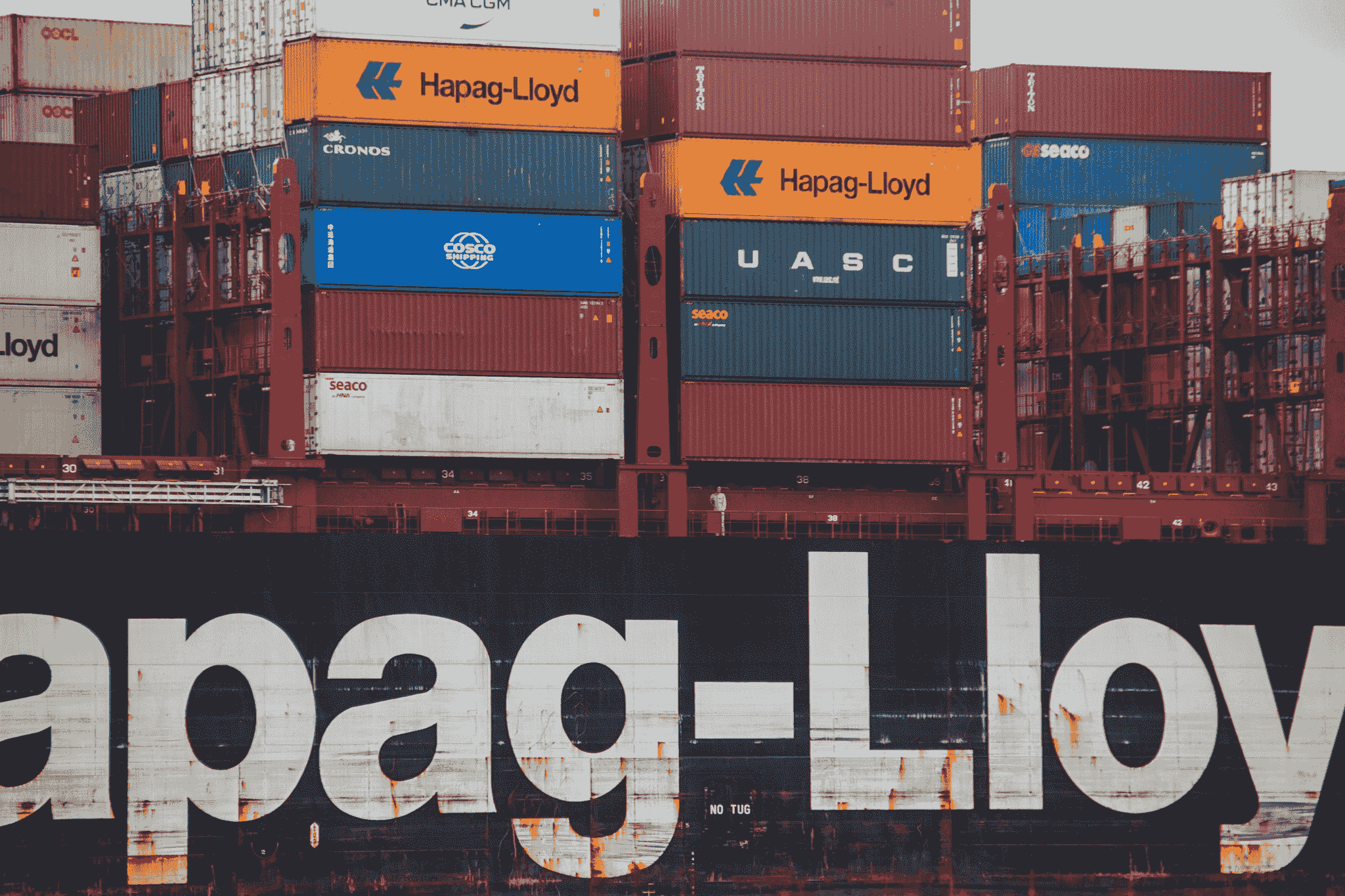Durable foldable container being loaded onto a cargo ship for global transportation.