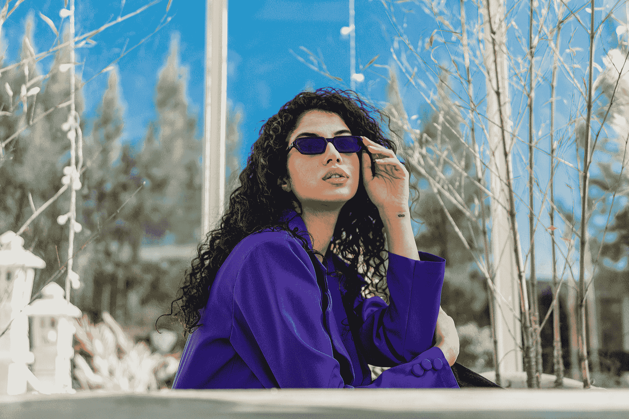 Fashionable woman showcasing thick rimmed glasses outdoors.