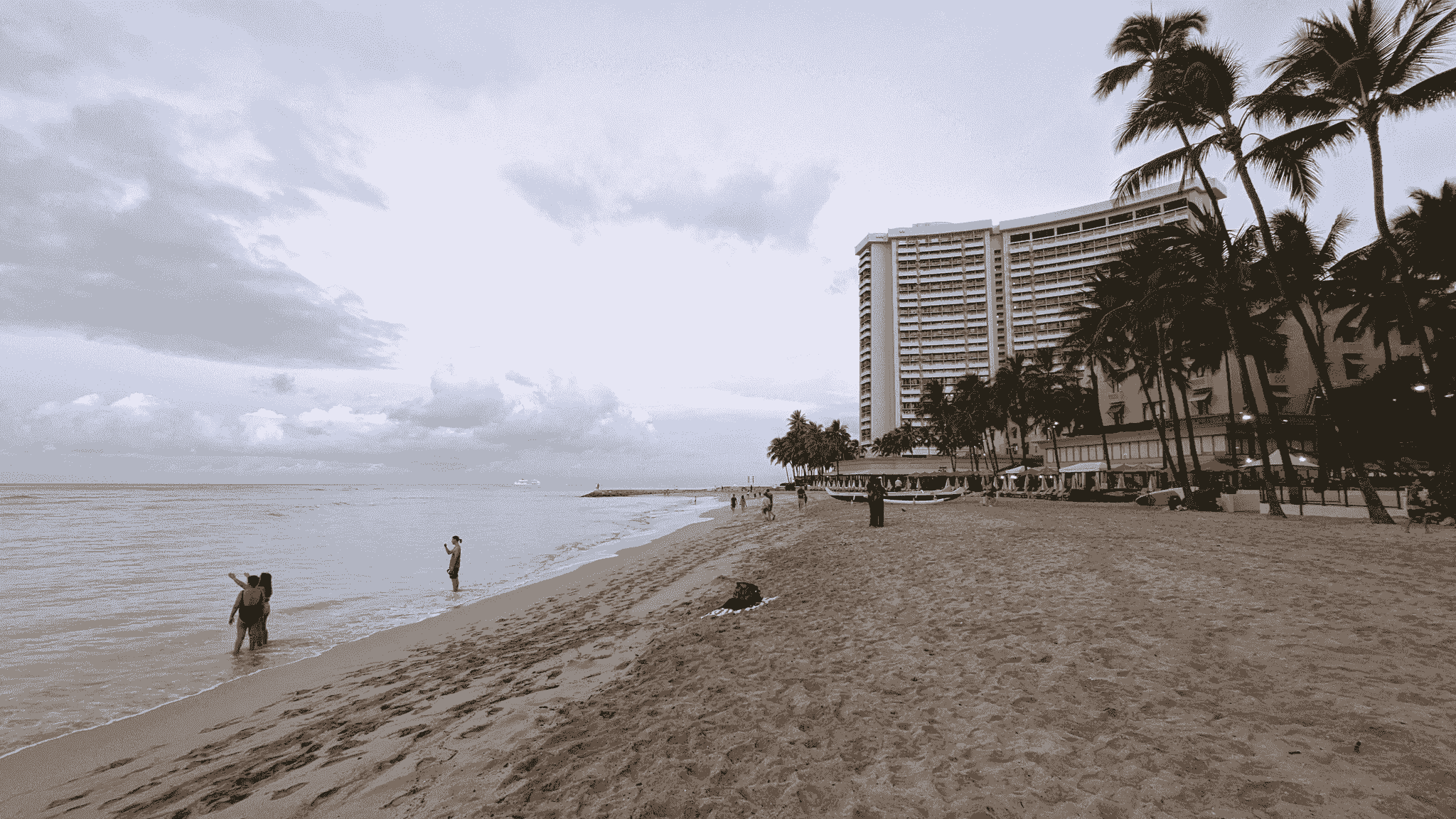 Families enjoying sunset on the beach at Aulani resorts