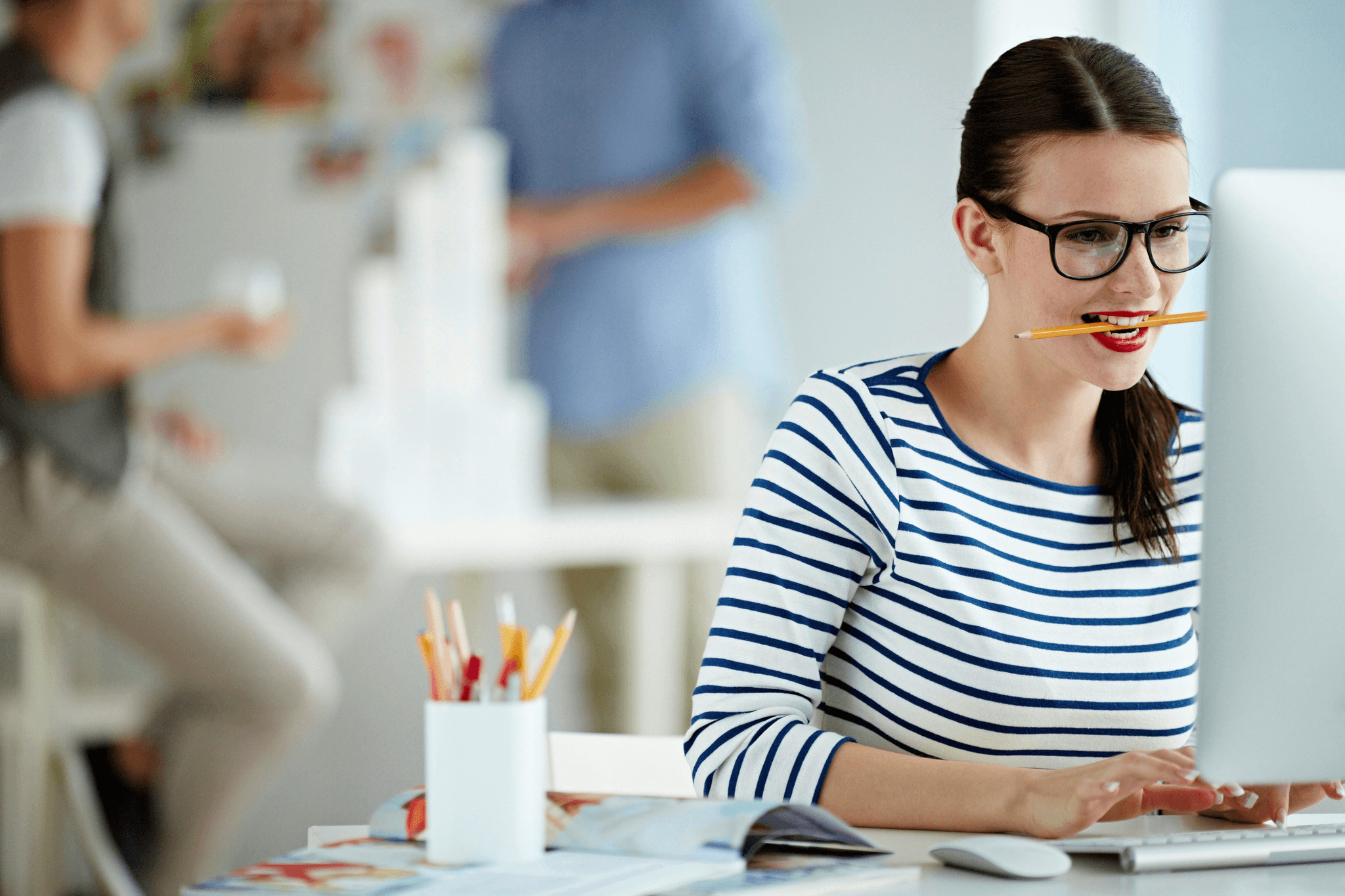 Woman wearing yellow tint glasses while working