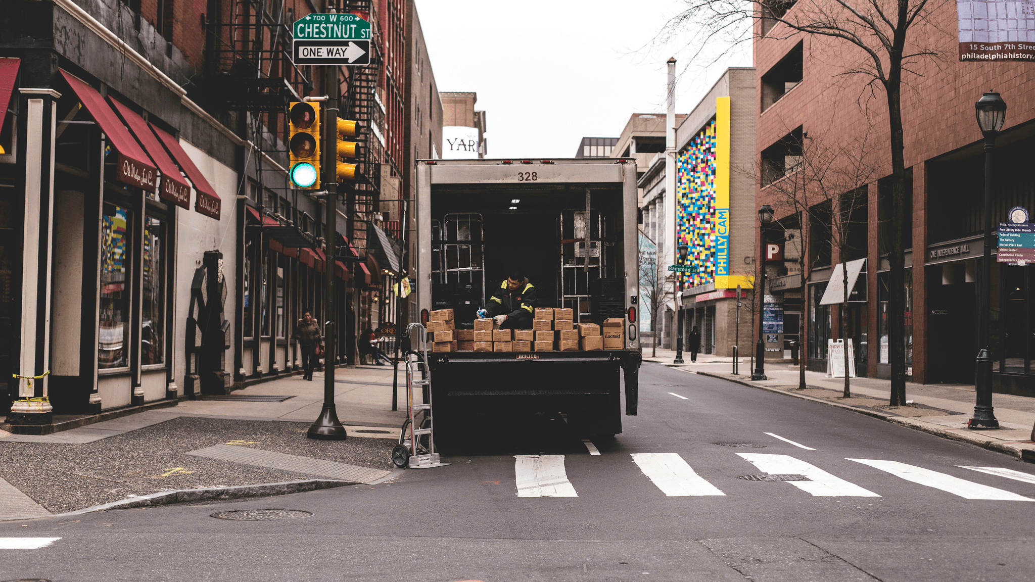 Foldable containers being loaded onto a truck for multi-modal transportation compatibility