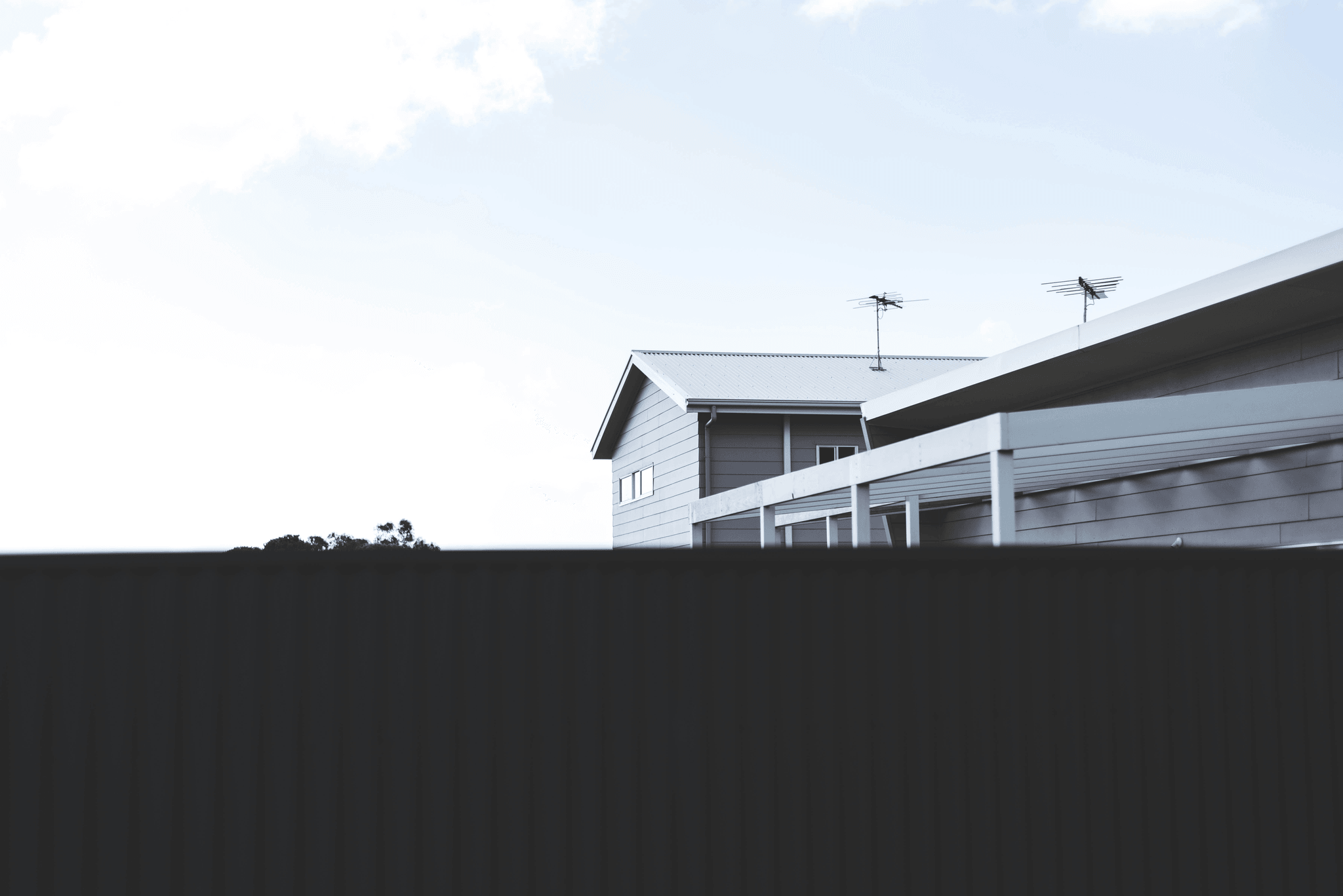 Happy homeowners standing in front of their conex container house