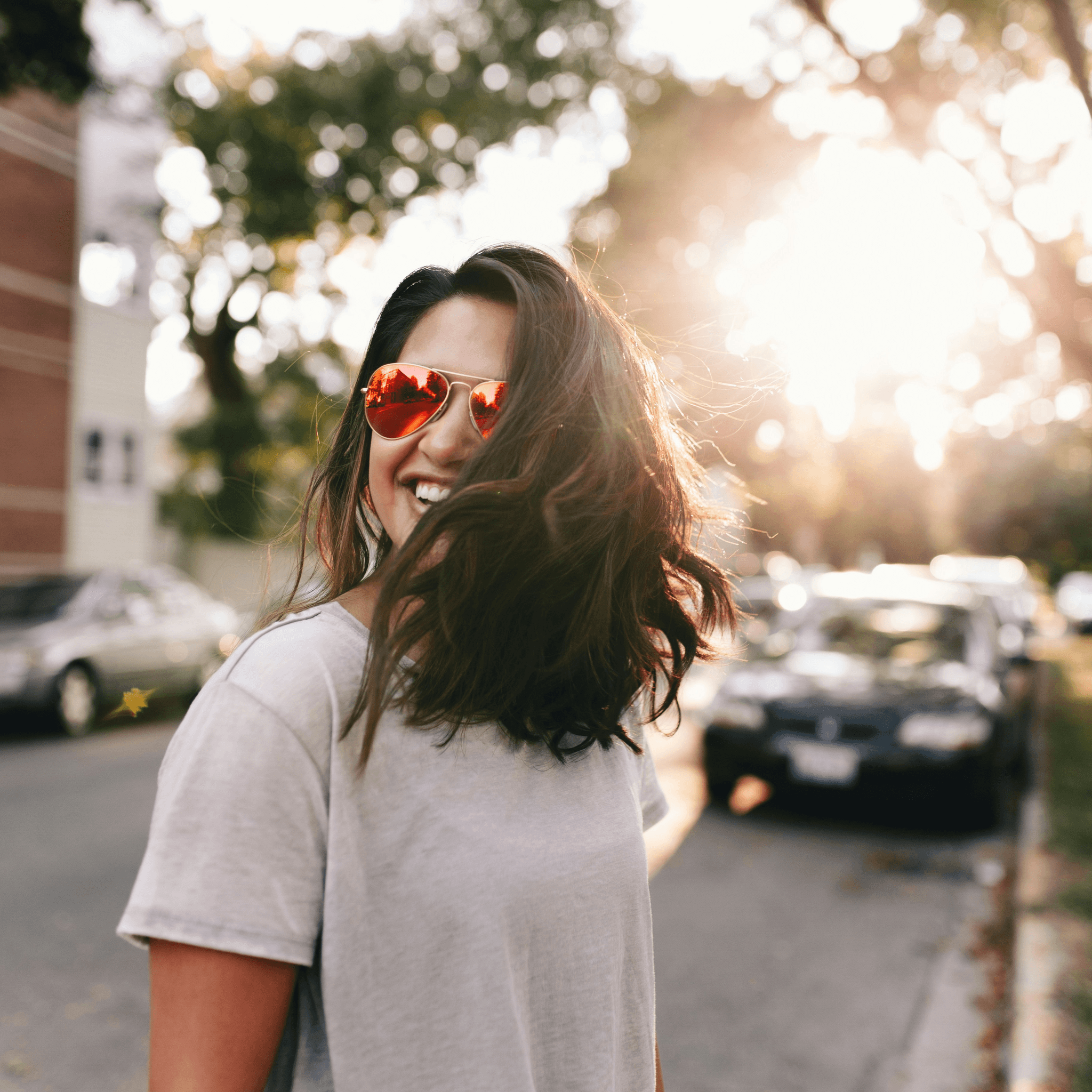 Stylish person in yellow tinted prescription glasses enjoying outdoor activities.