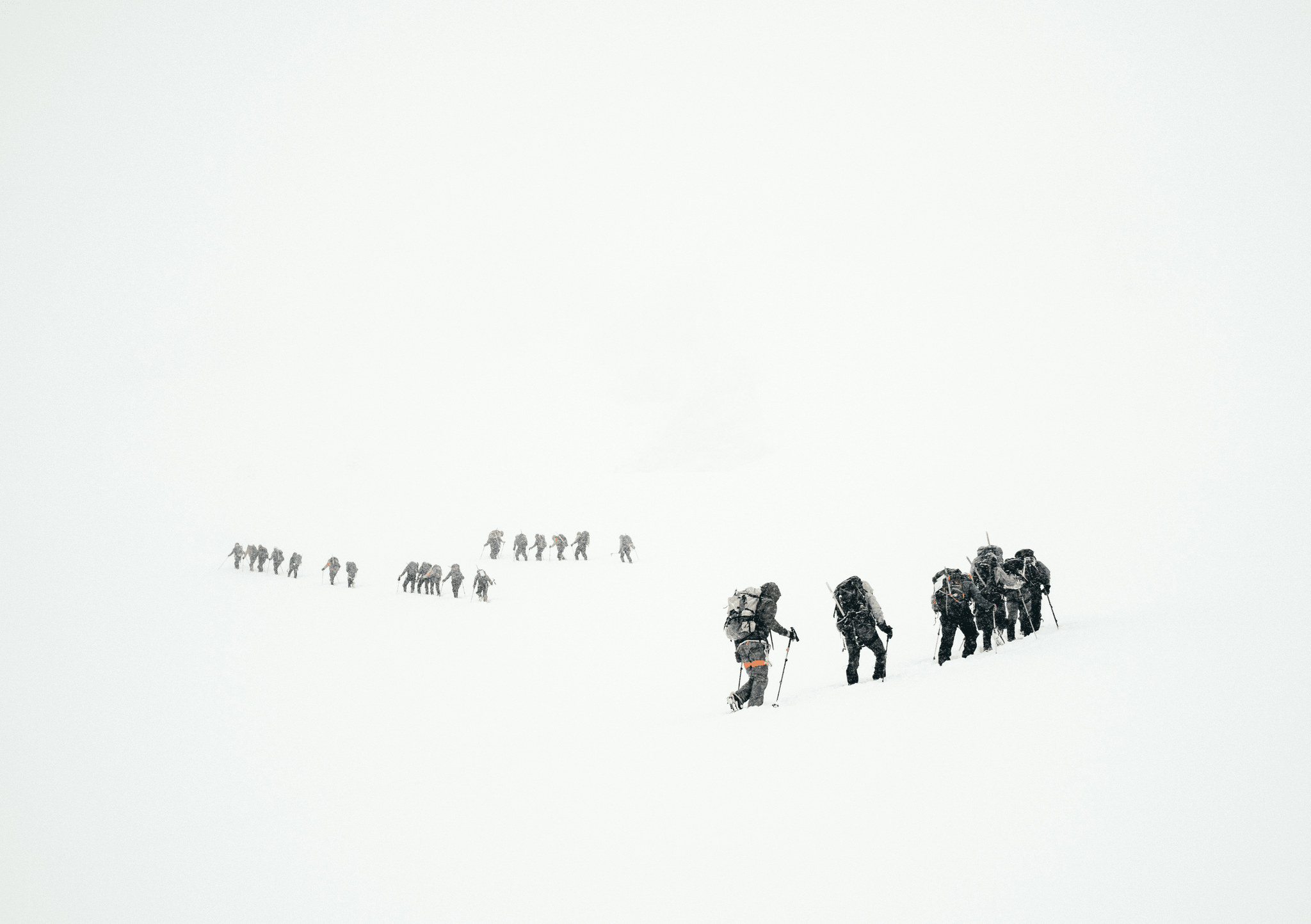 Climbing Mount Everest expedition group trekking through snow-covered mountains