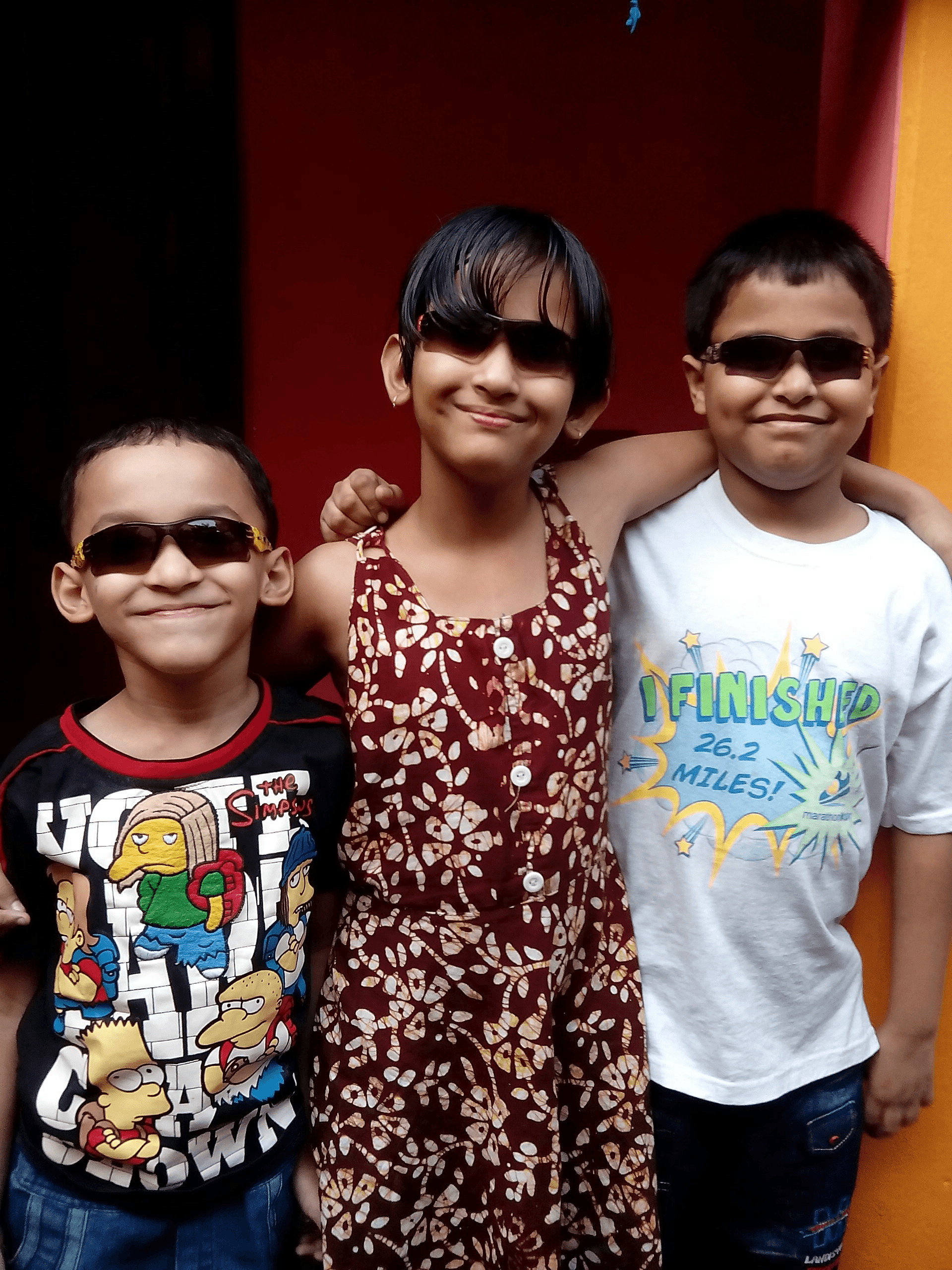 Kids wearing colorful sunglasses at an outdoor birthday party
