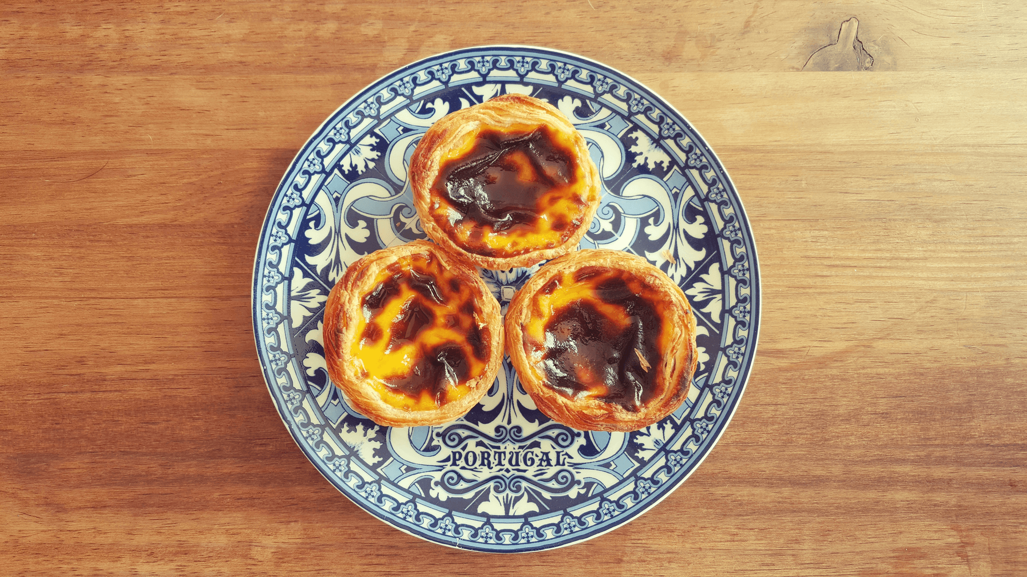 Portuguese Pastel de Nata on traditional plate in Madeira cooking class