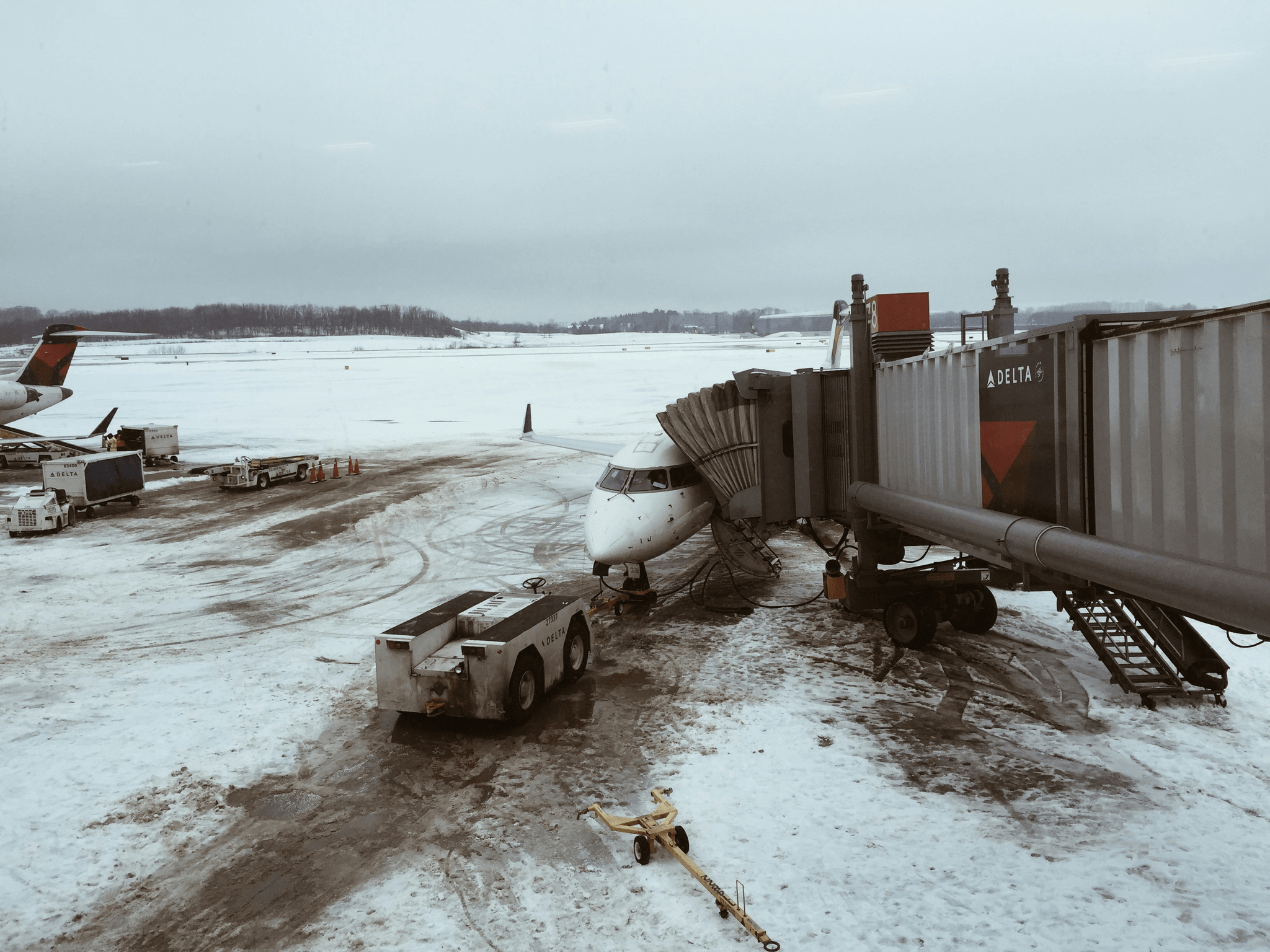 Truck mounted snow blower clearing airport runway efficiently.