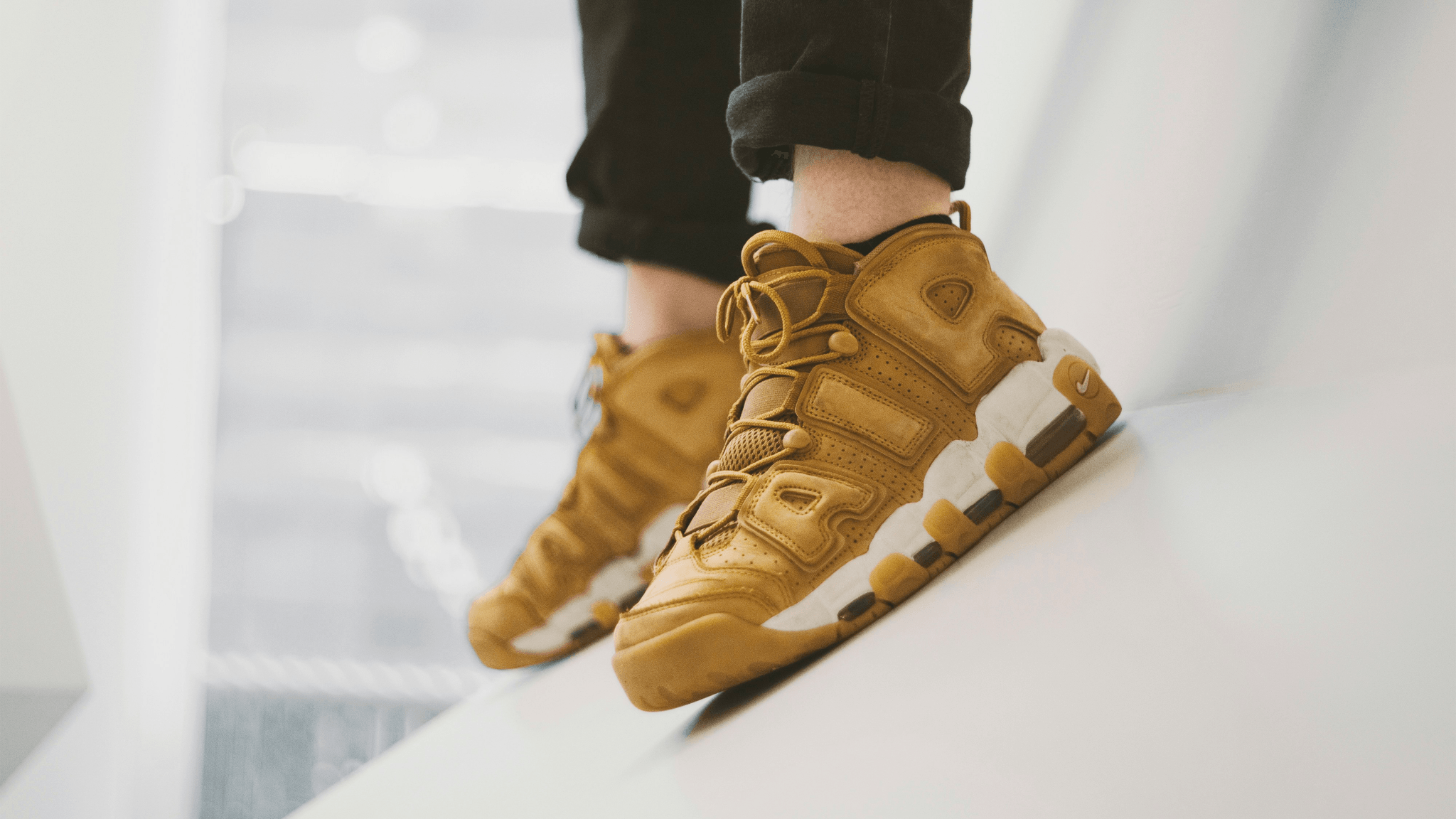 Footwear inspection assessing fit and comfort during quality control.