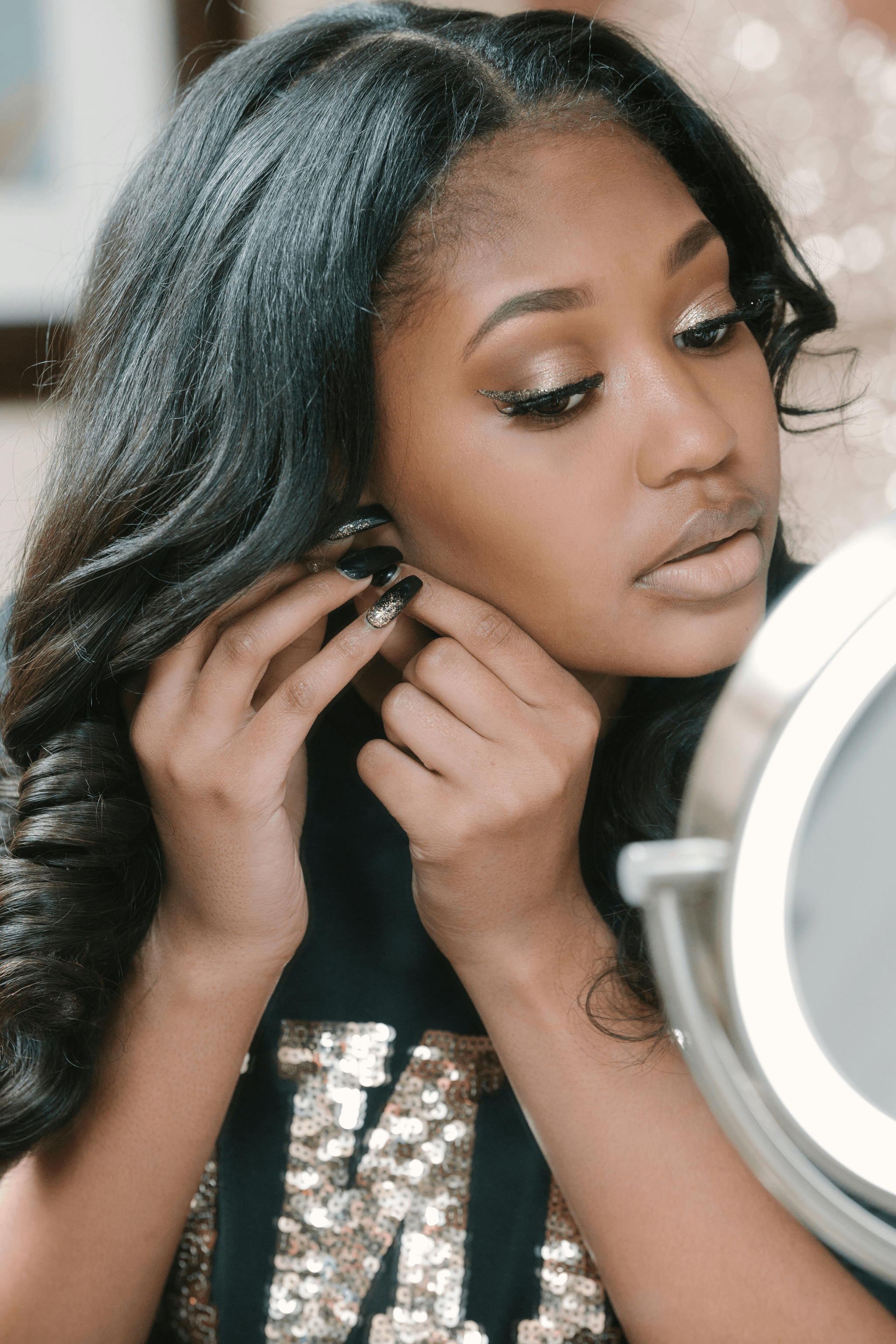 woman applying clip in extensions for beautiful hairstyle